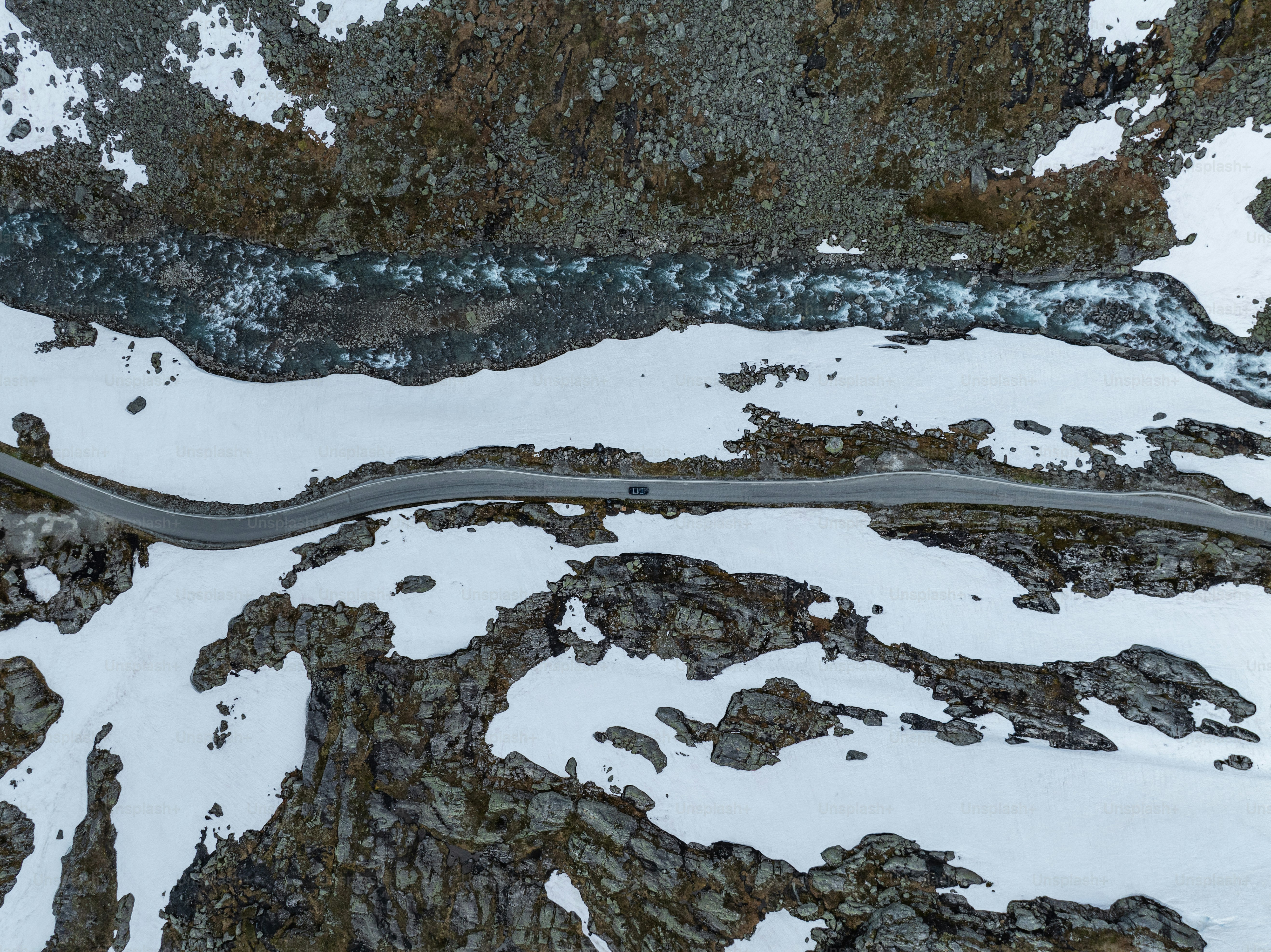 An aerial view of a winding road in the mountains
