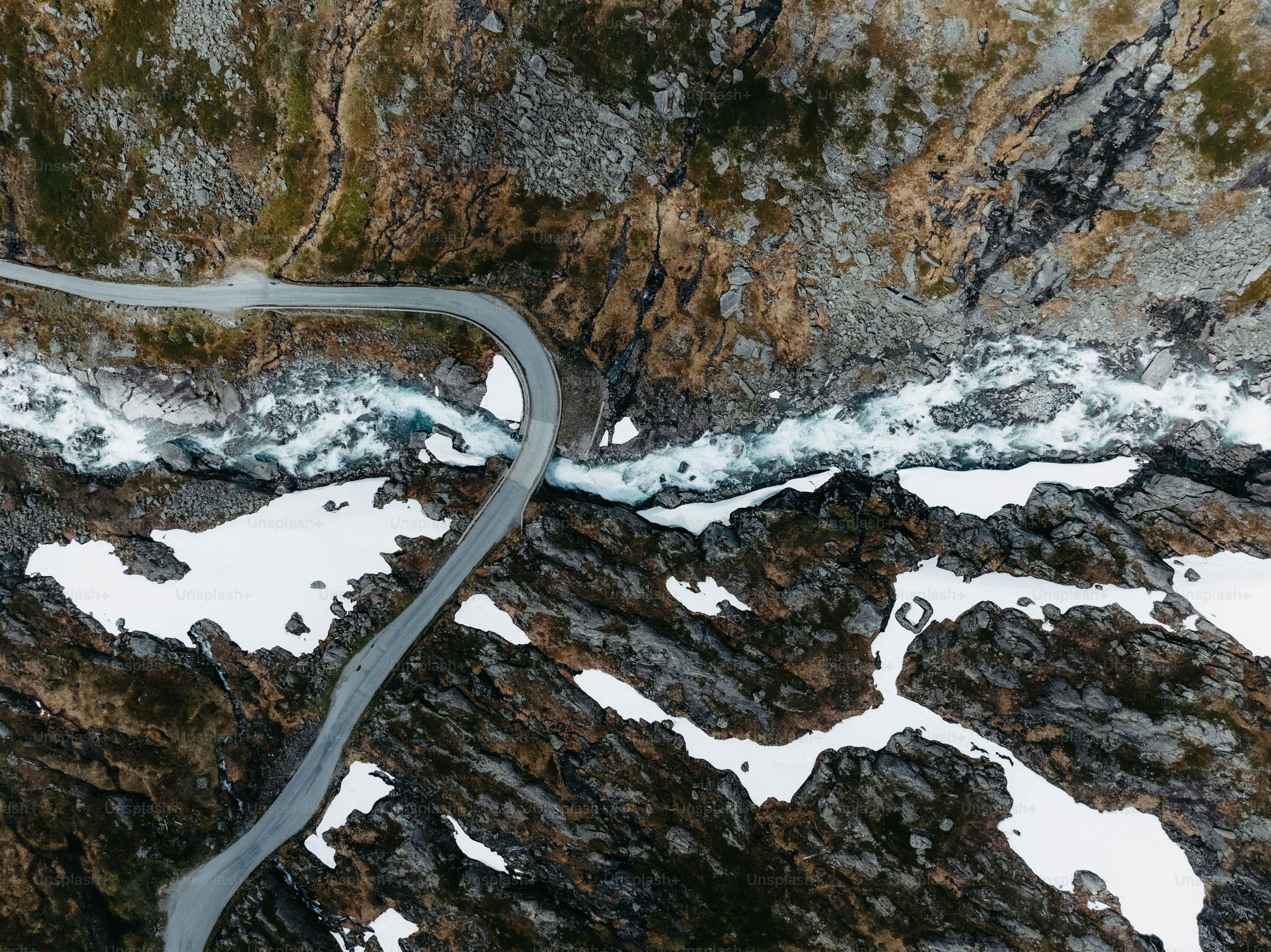 An aerial view of a winding road in the mountains