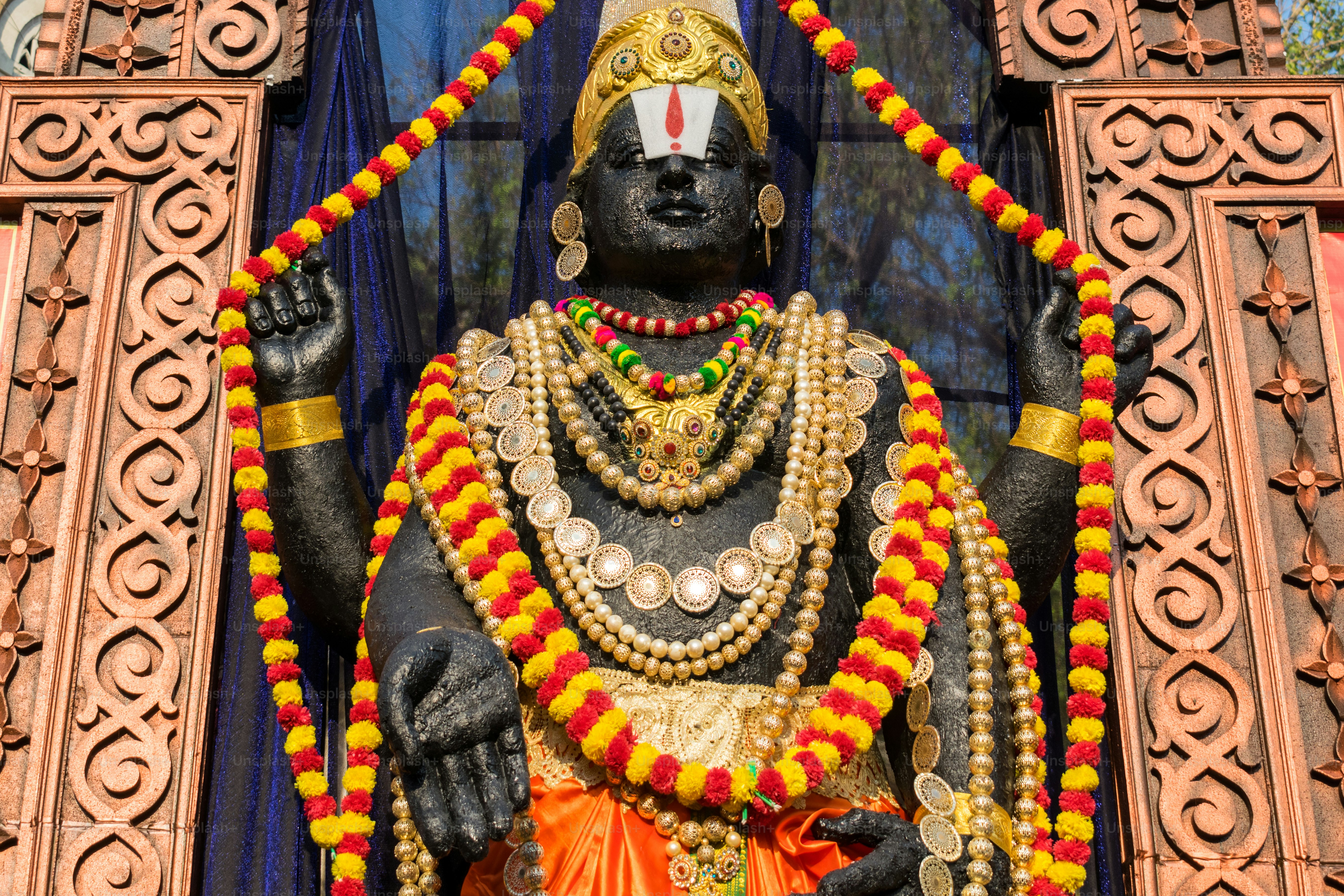 A statue of a hindu god in front of a building