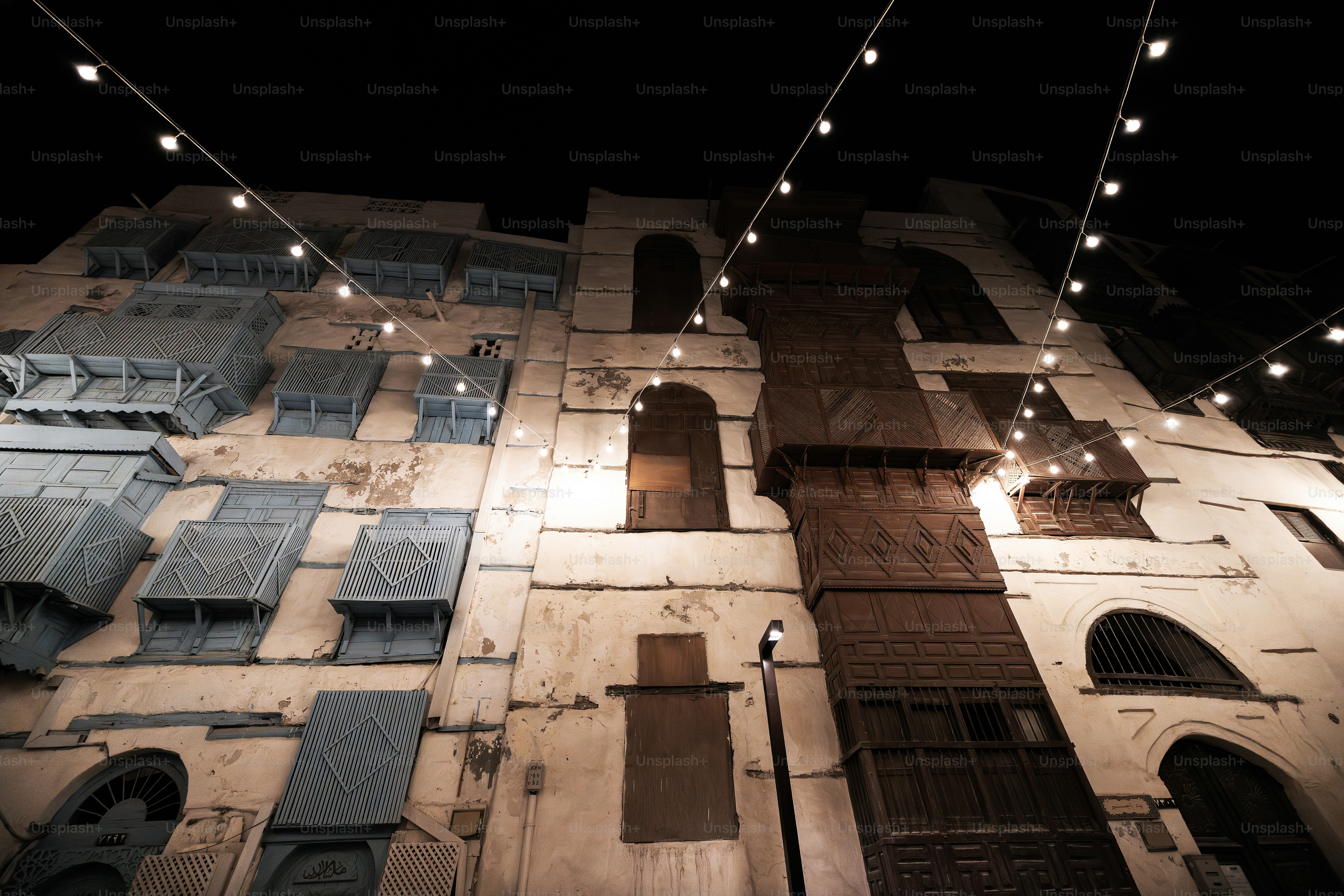A tall building with a string of lights hanging from it's side