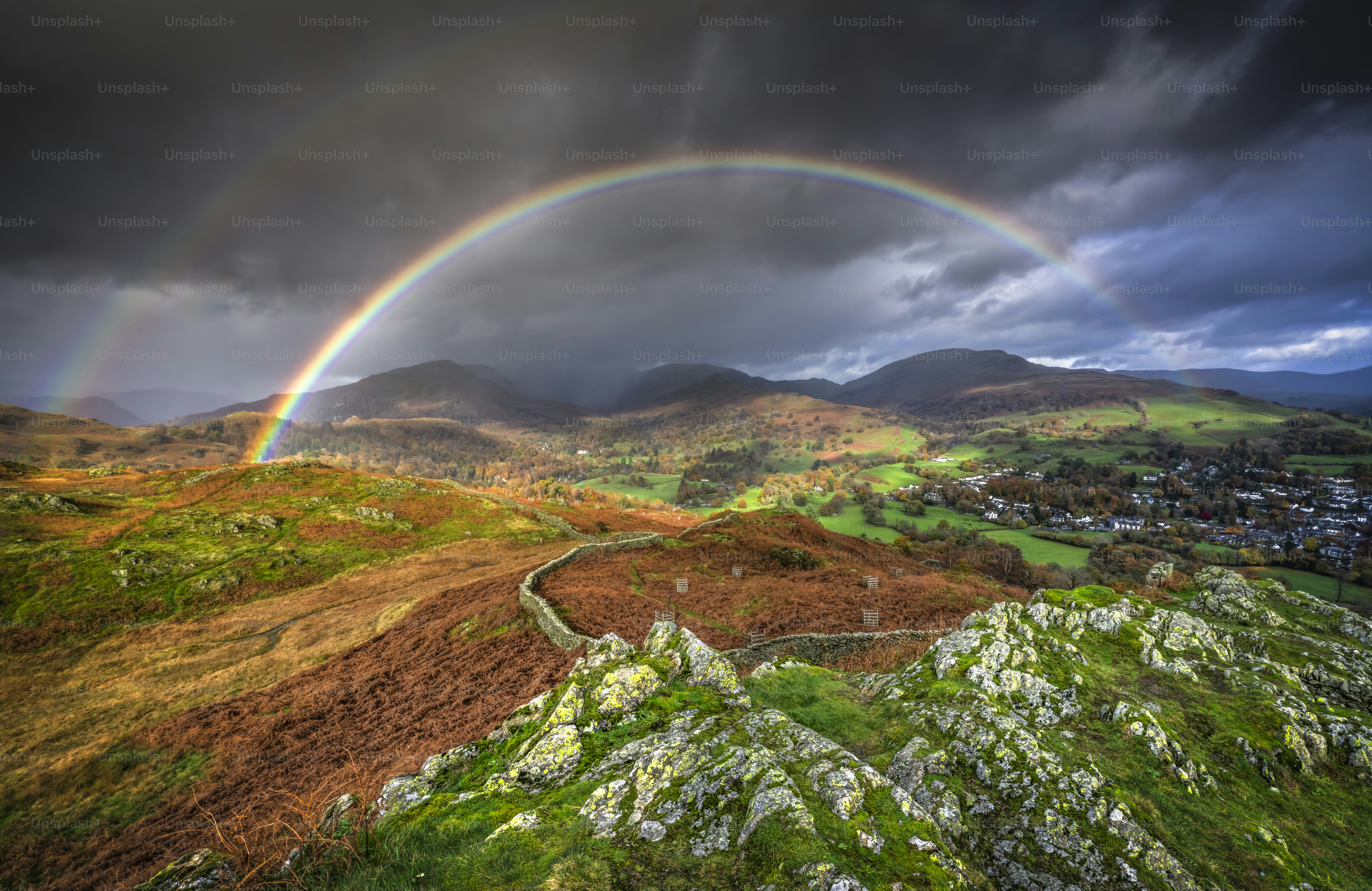 Two rainbows are seen over a green valley