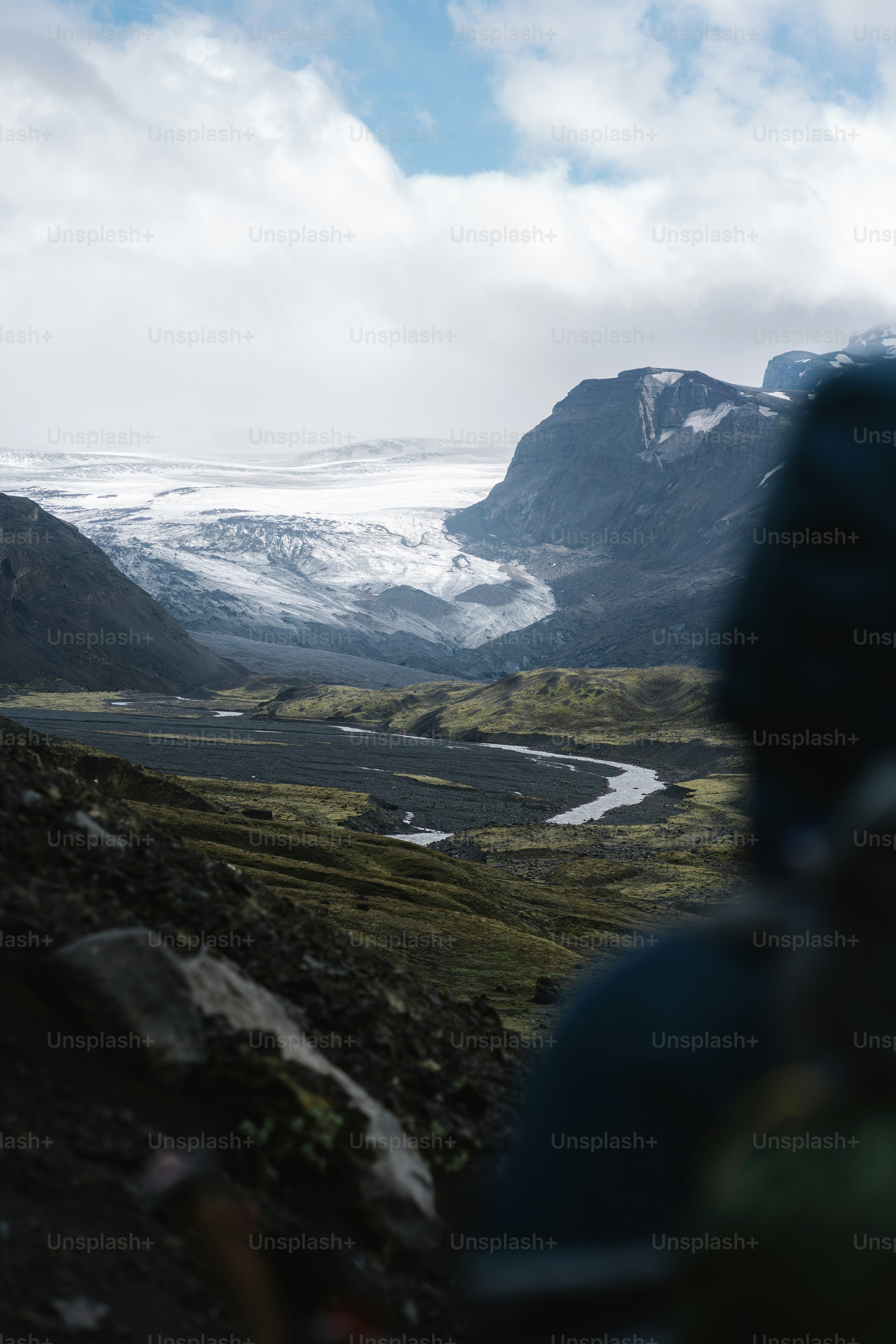 Un uomo in piedi in cima a una collina verde lussureggiante