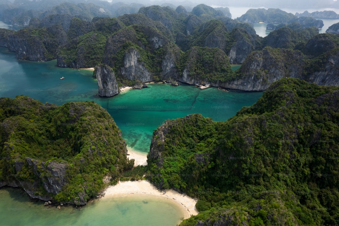 An aerial view of an island with a sandy beach