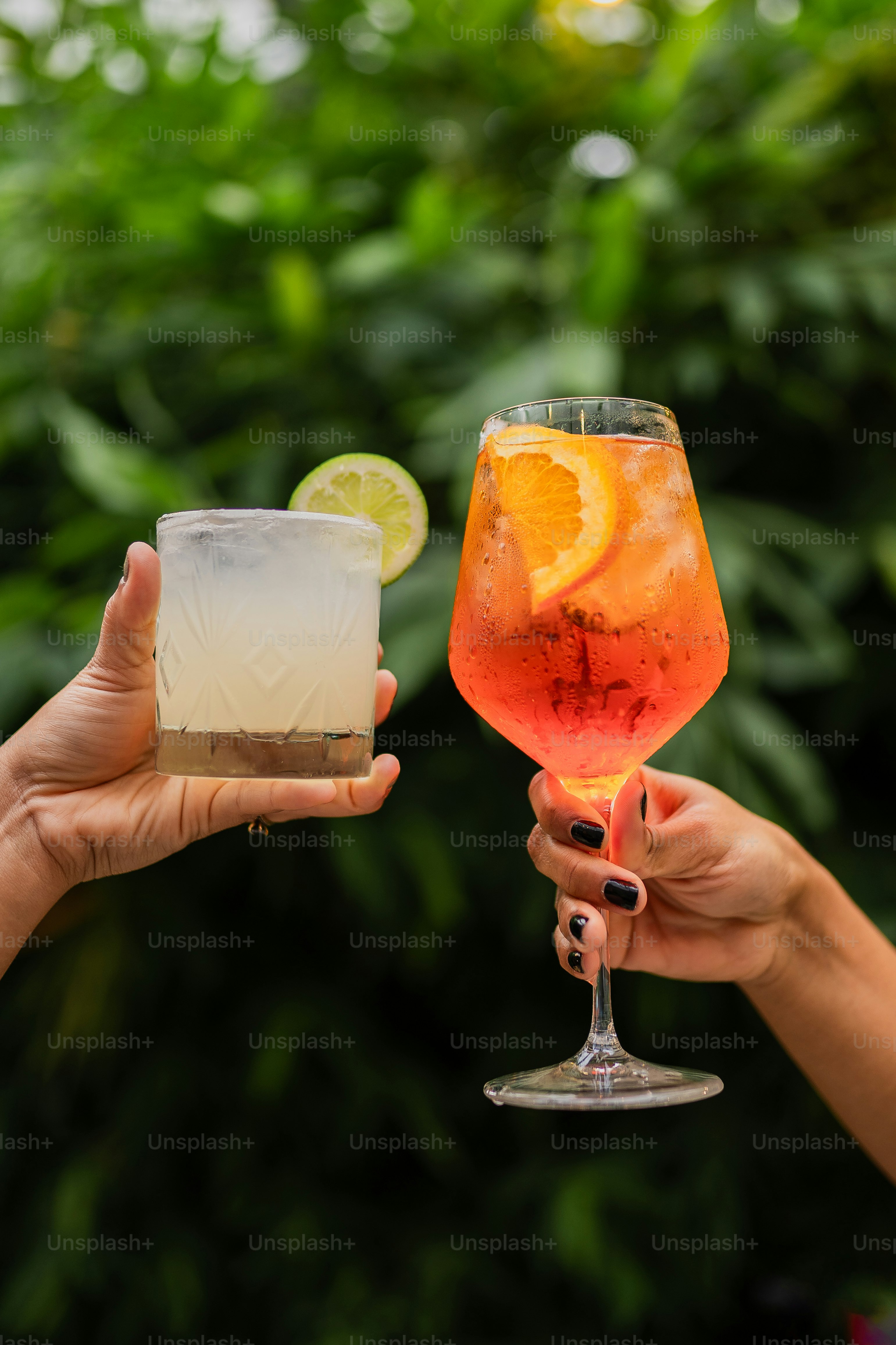 A couple of people holding up drinks in their hands