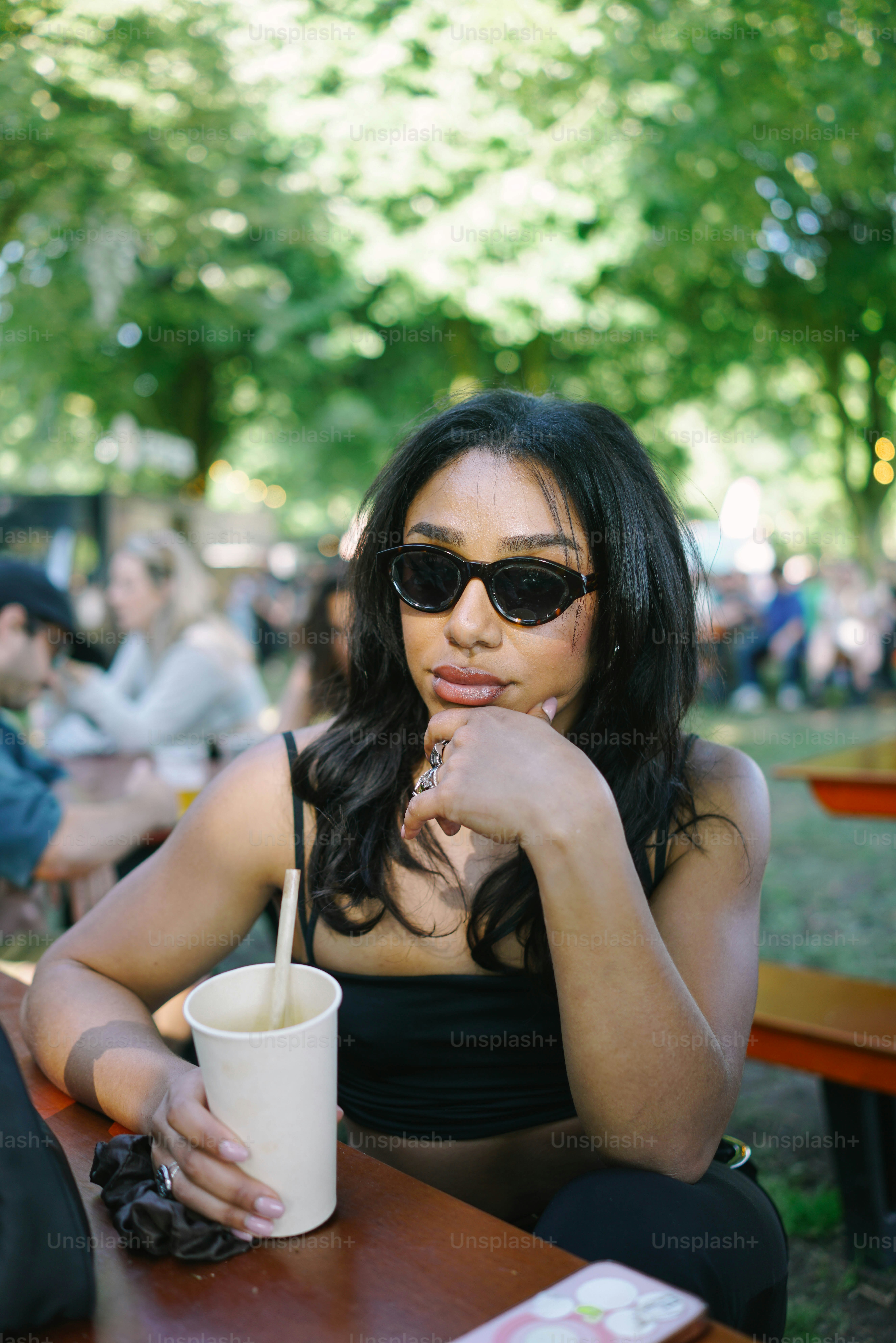 A woman sitting at a table with a cup of coffee