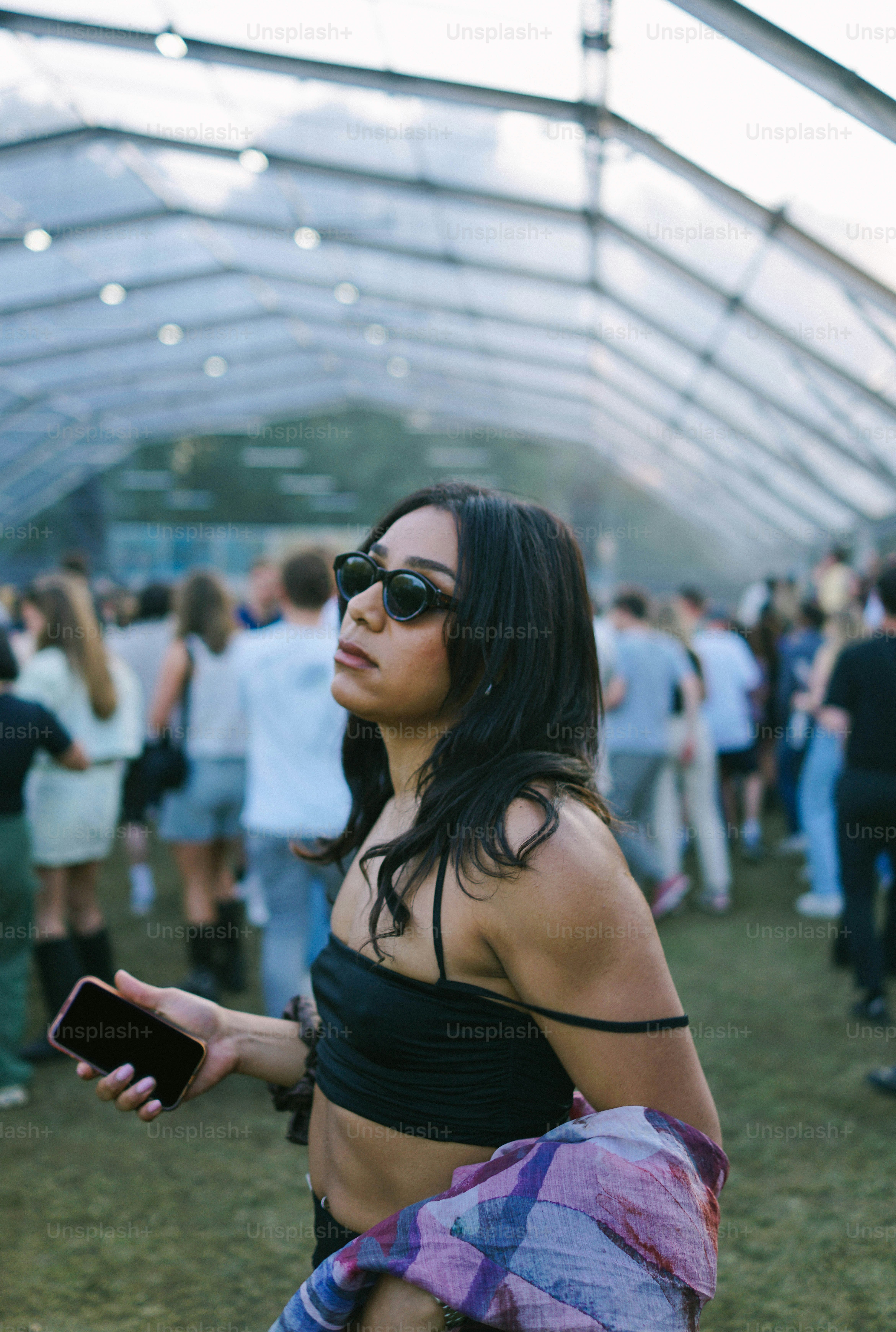 A woman in a black top is standing in a crowd