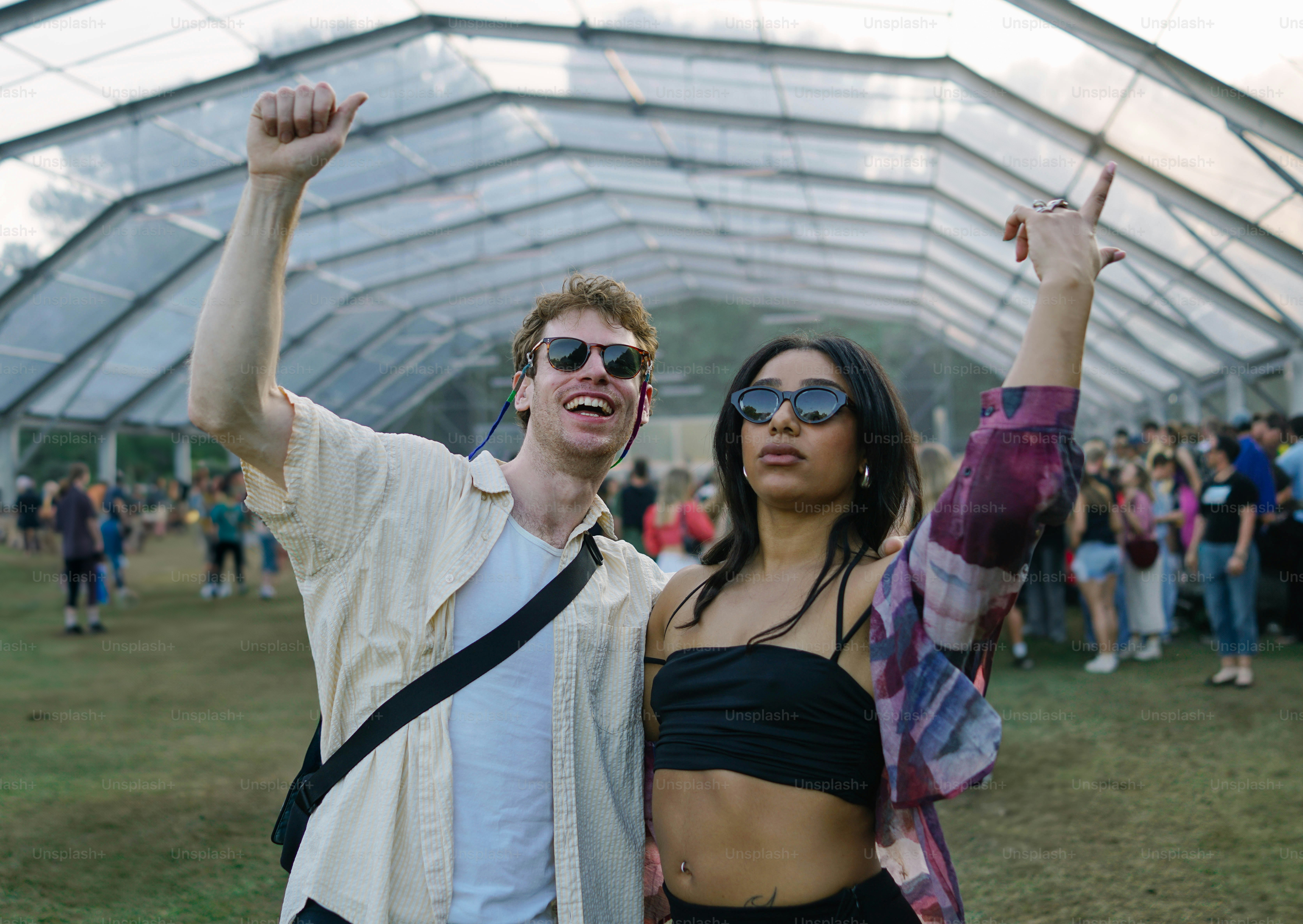 A couple of people that are standing in the grass
