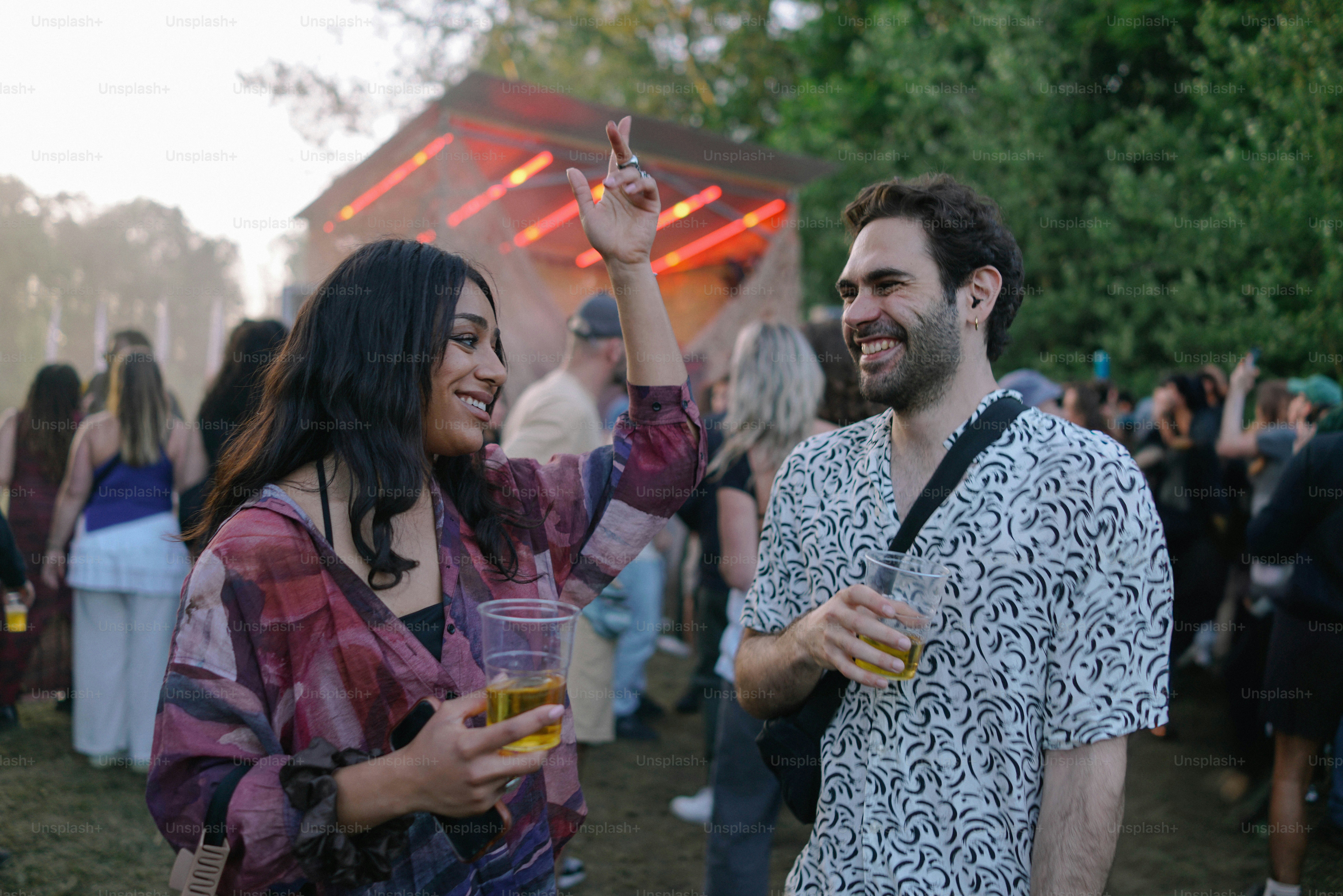 A man and a woman standing next to each other at a music festival