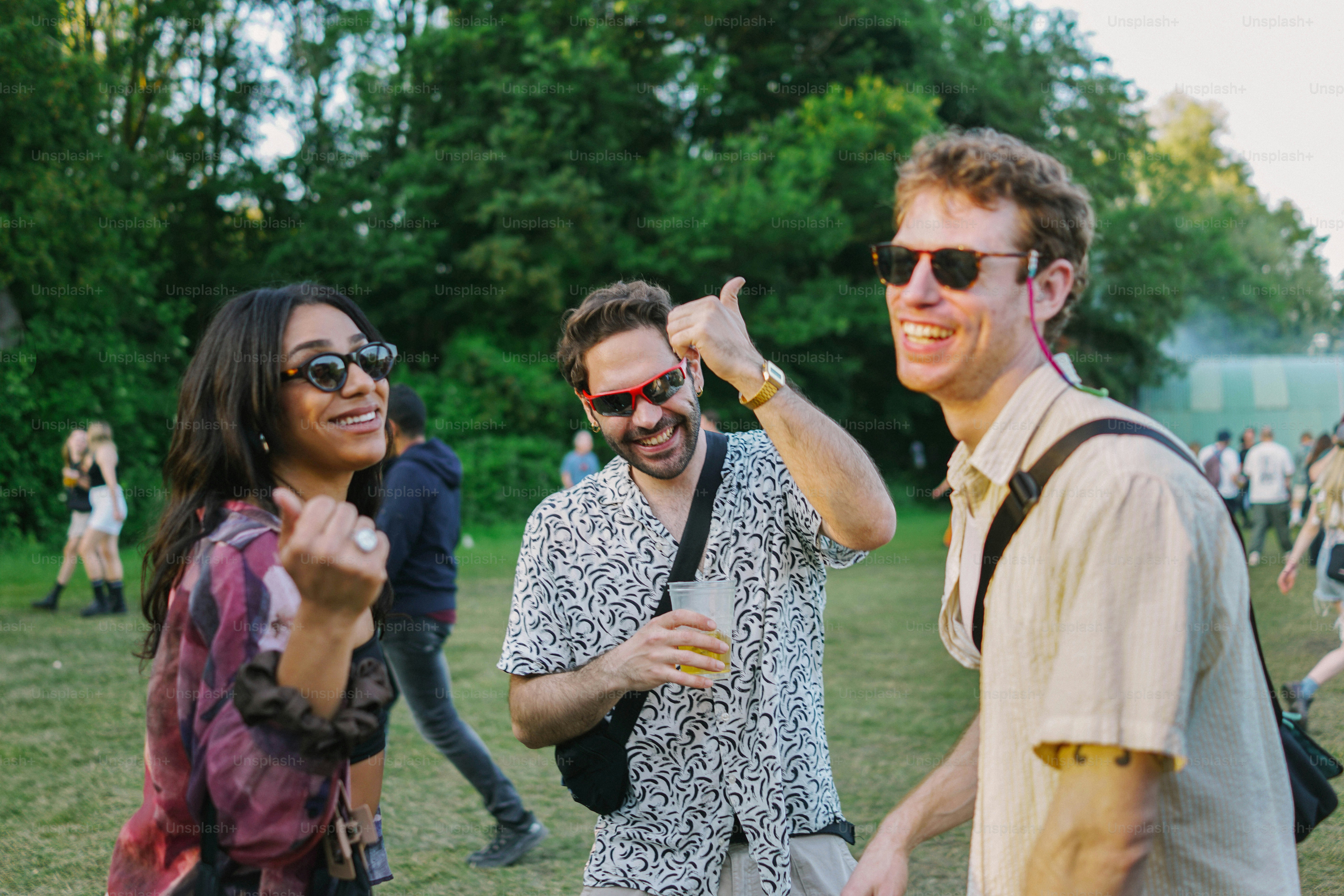 A group of people standing on top of a lush green field