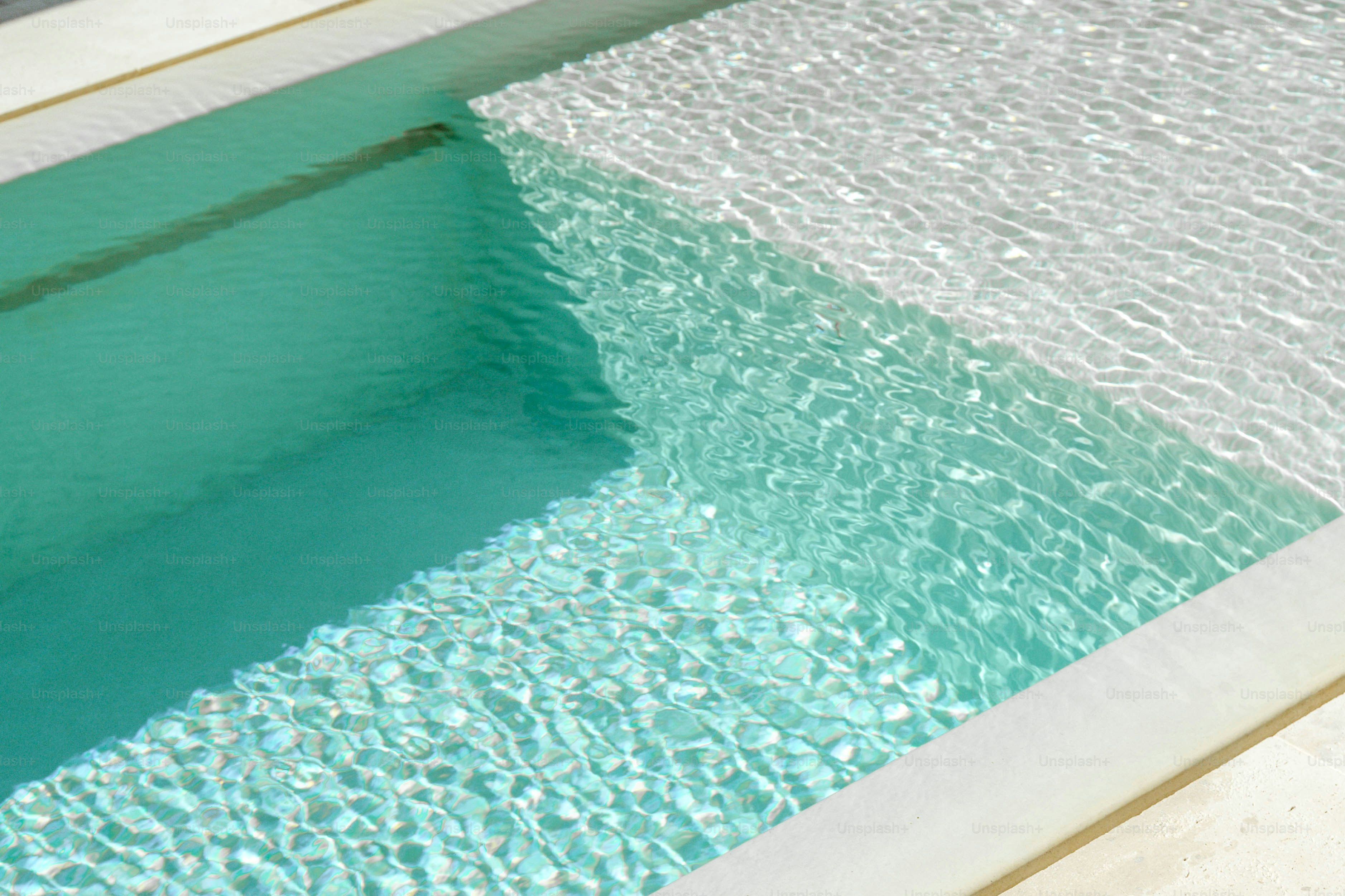 An empty swimming pool with clear blue water