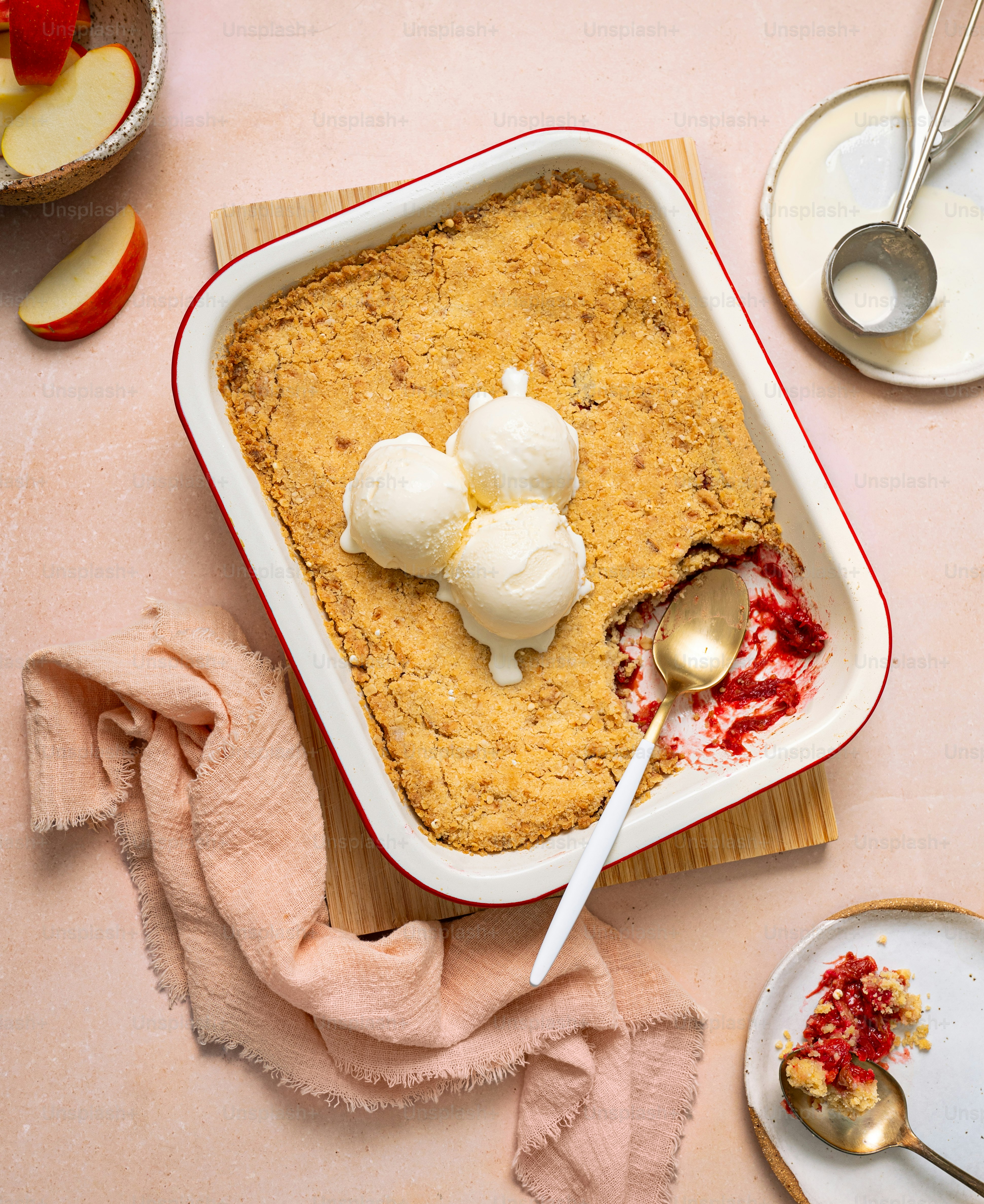 A table topped with a casserole covered in ice cream
