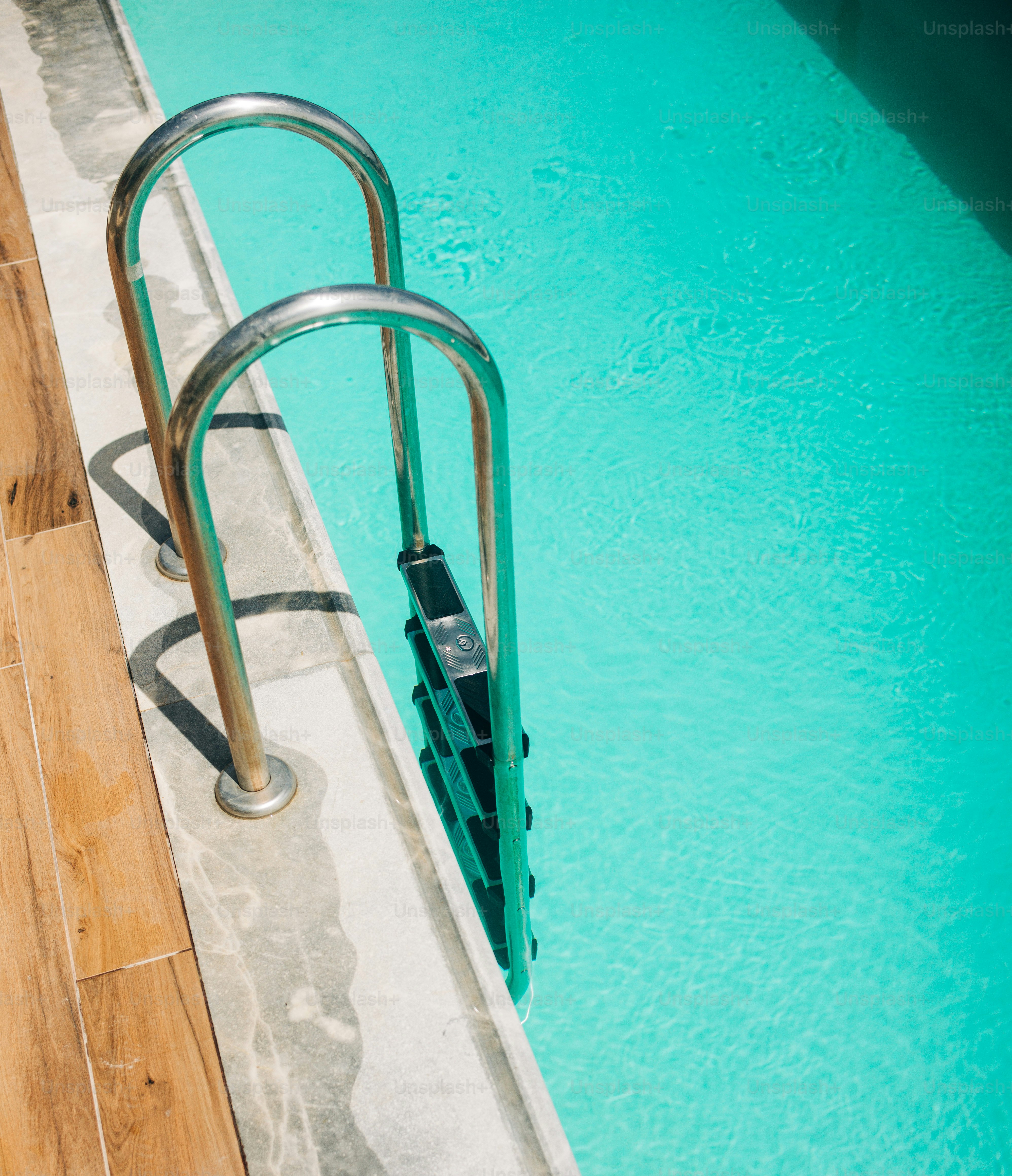 A swimming pool with a metal handrail next to it