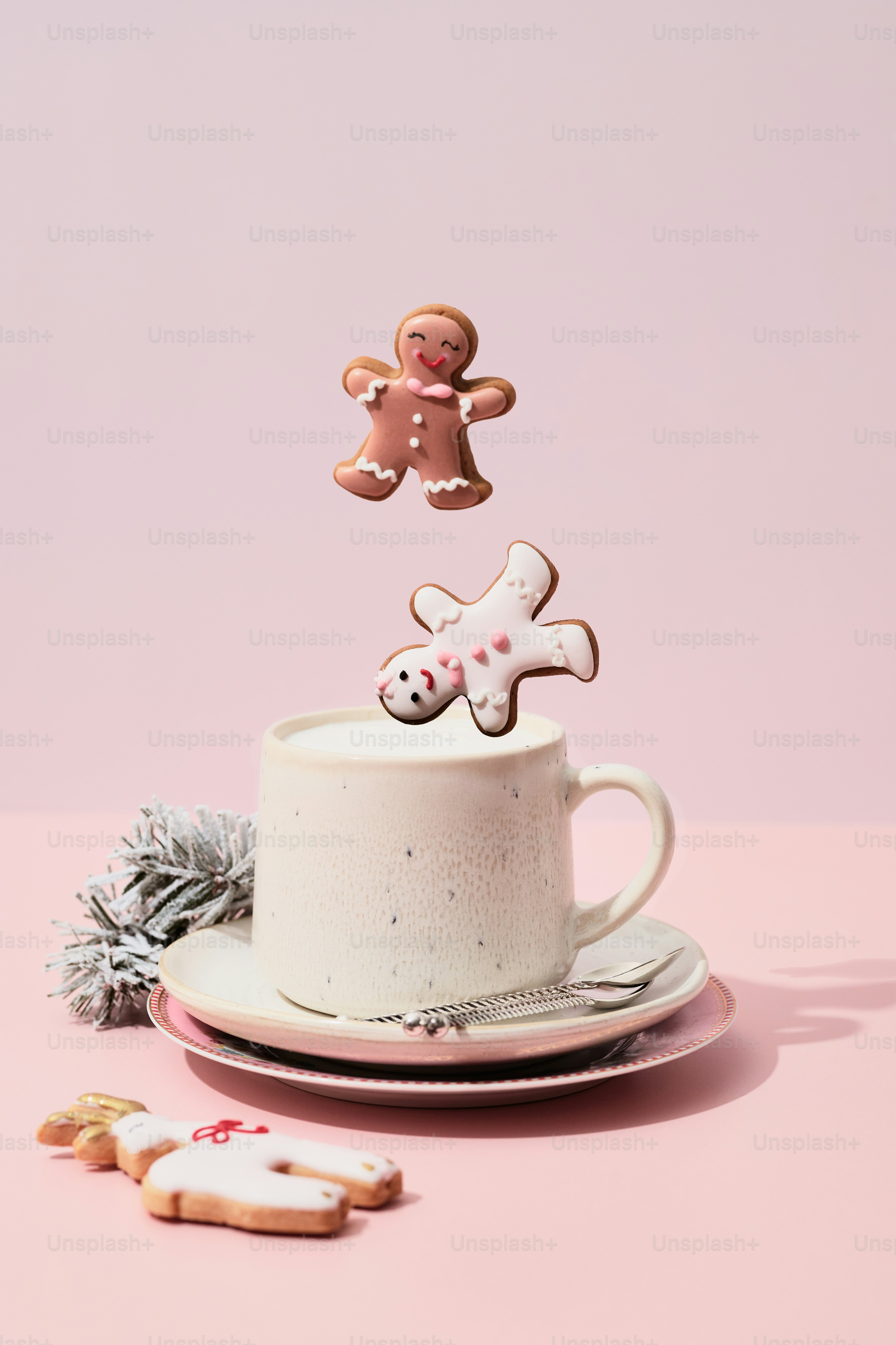 A cup of coffee with a cookie on top of it