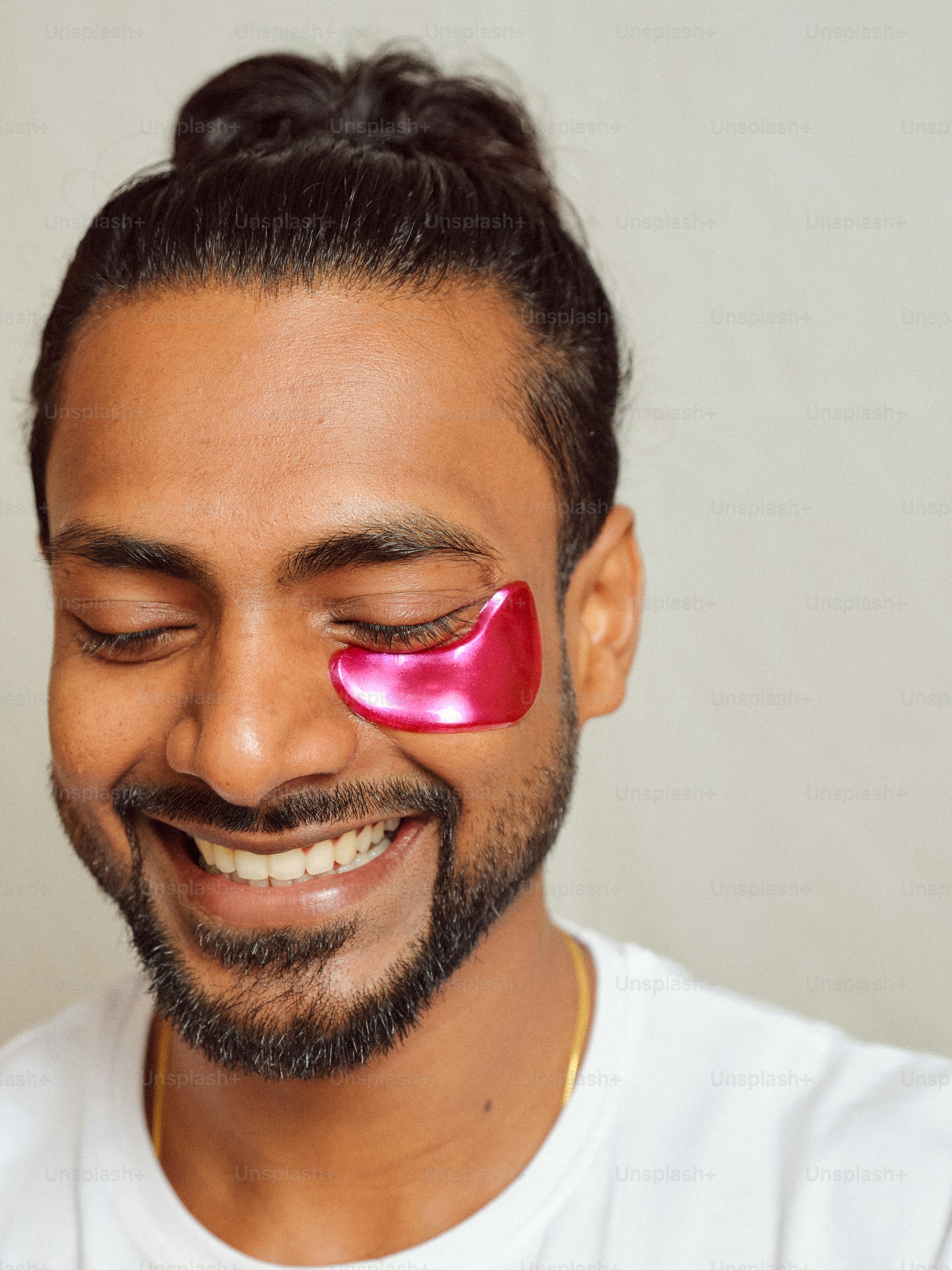 A man with a pink eye patch on his face