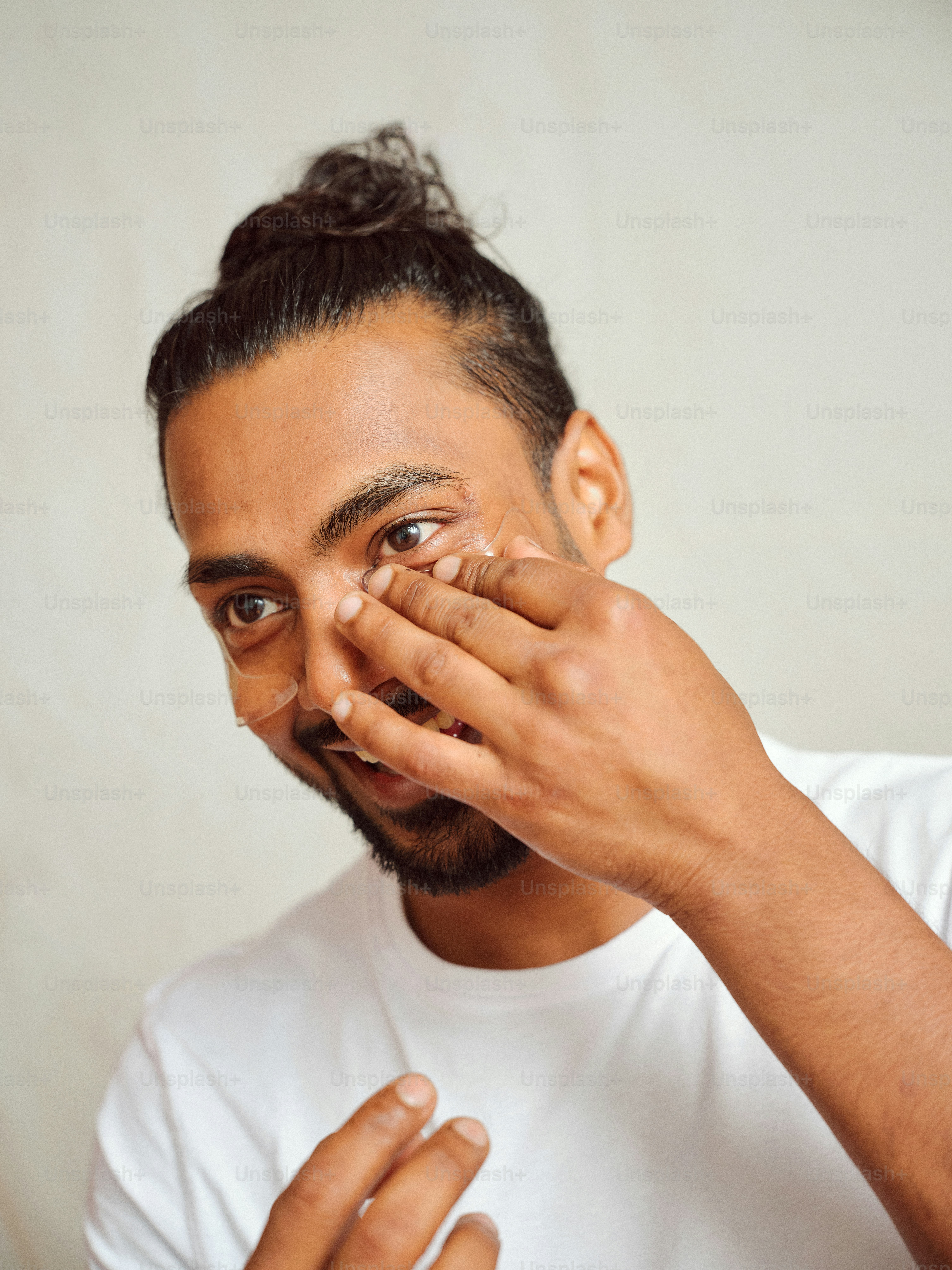 A man holding his hand to his face