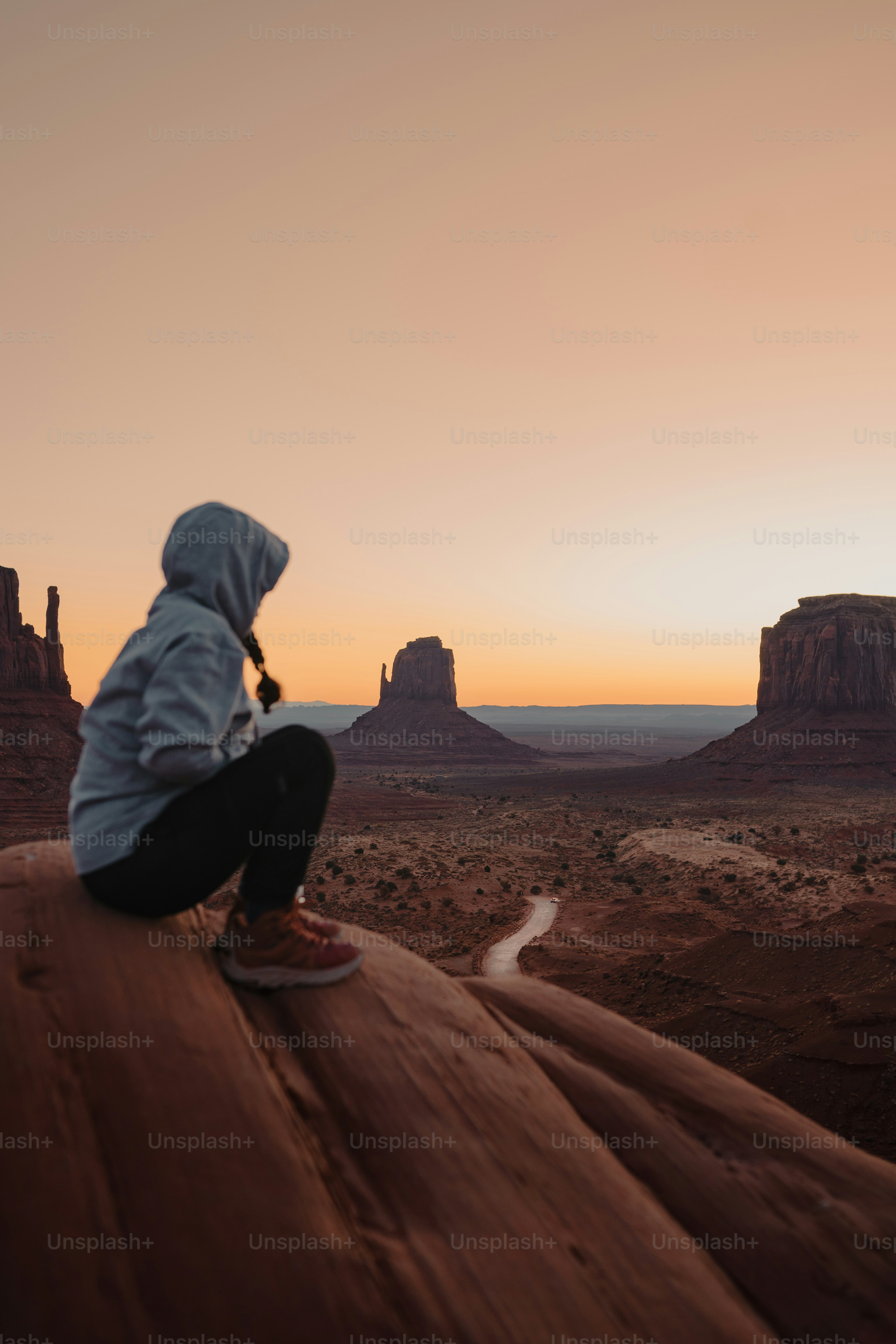 A person sitting on a rock in the desert