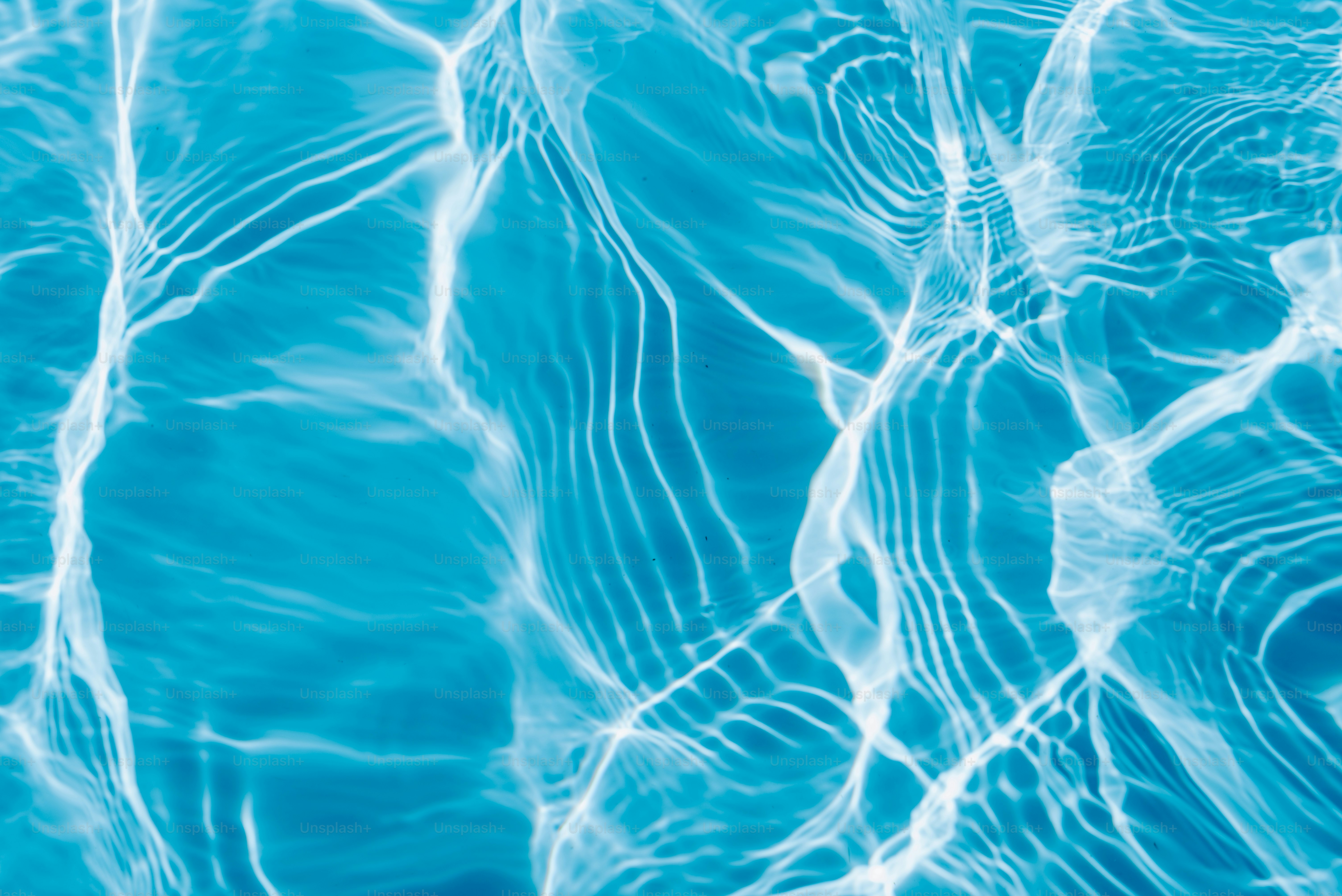 A close up of a blue water surface photo – Ripples Image on Unsplash