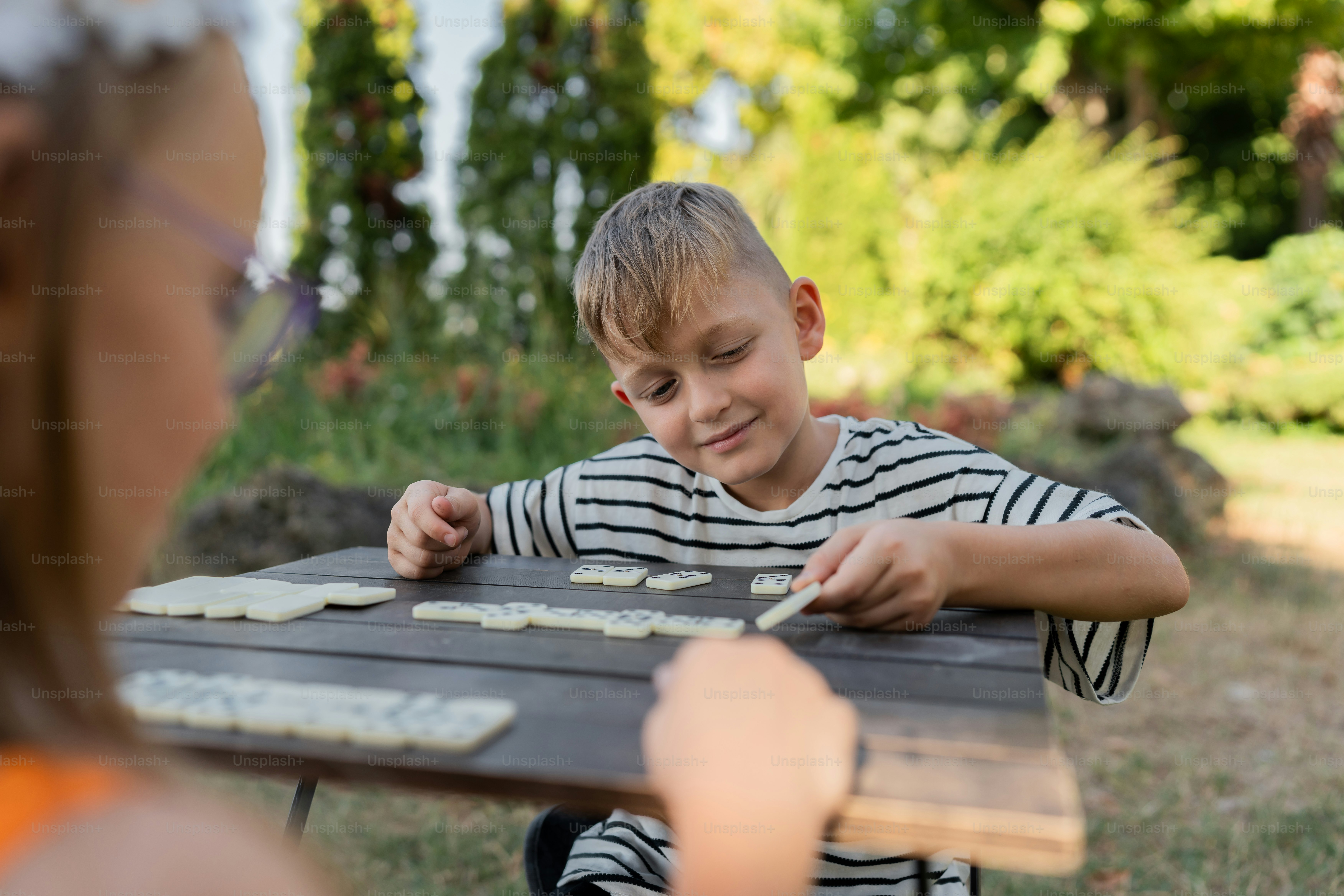 A boy and a girl playing a game of checkers