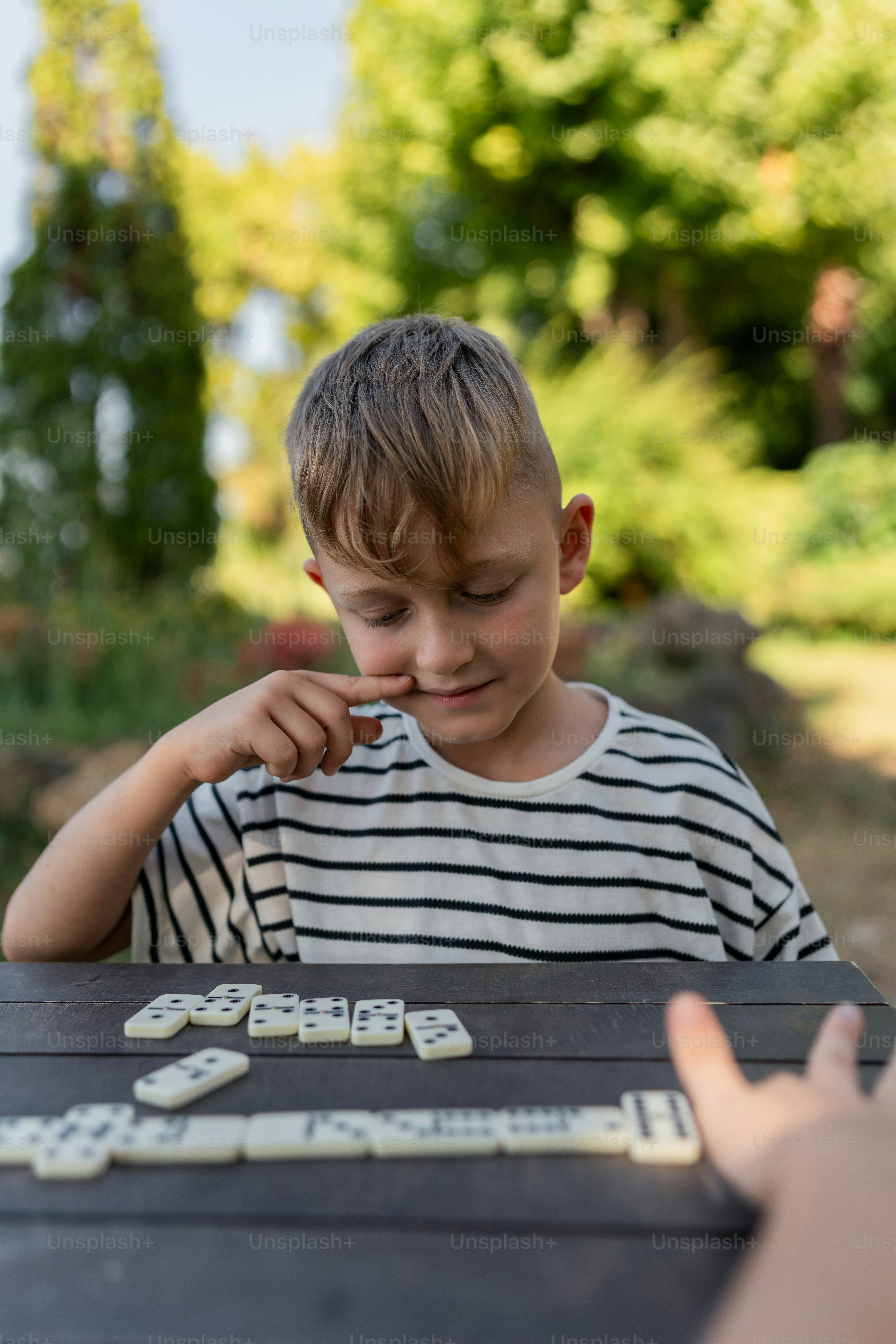 A little boy sitting at a table with a piece of cake