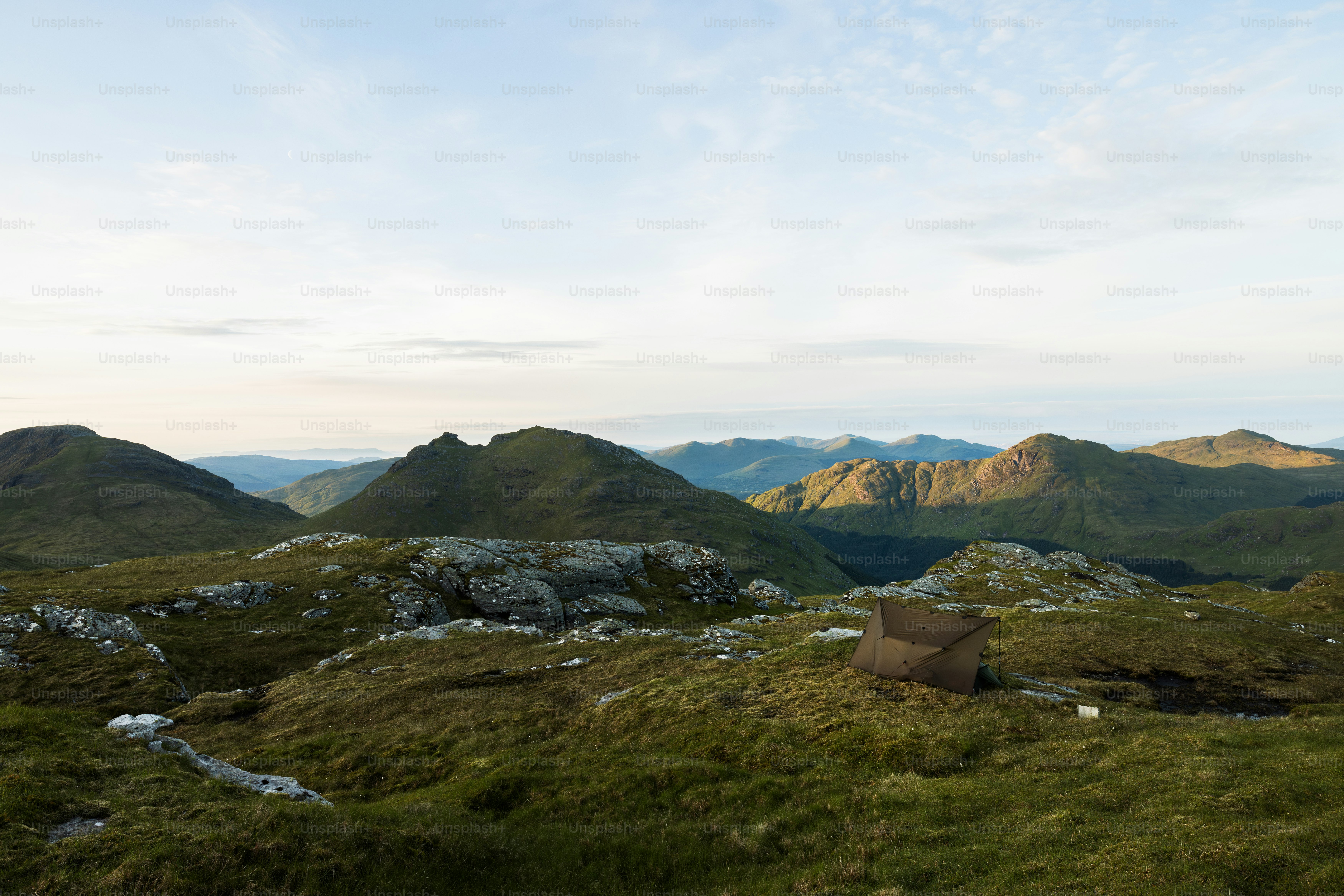 A view of the mountains from a grassy hill