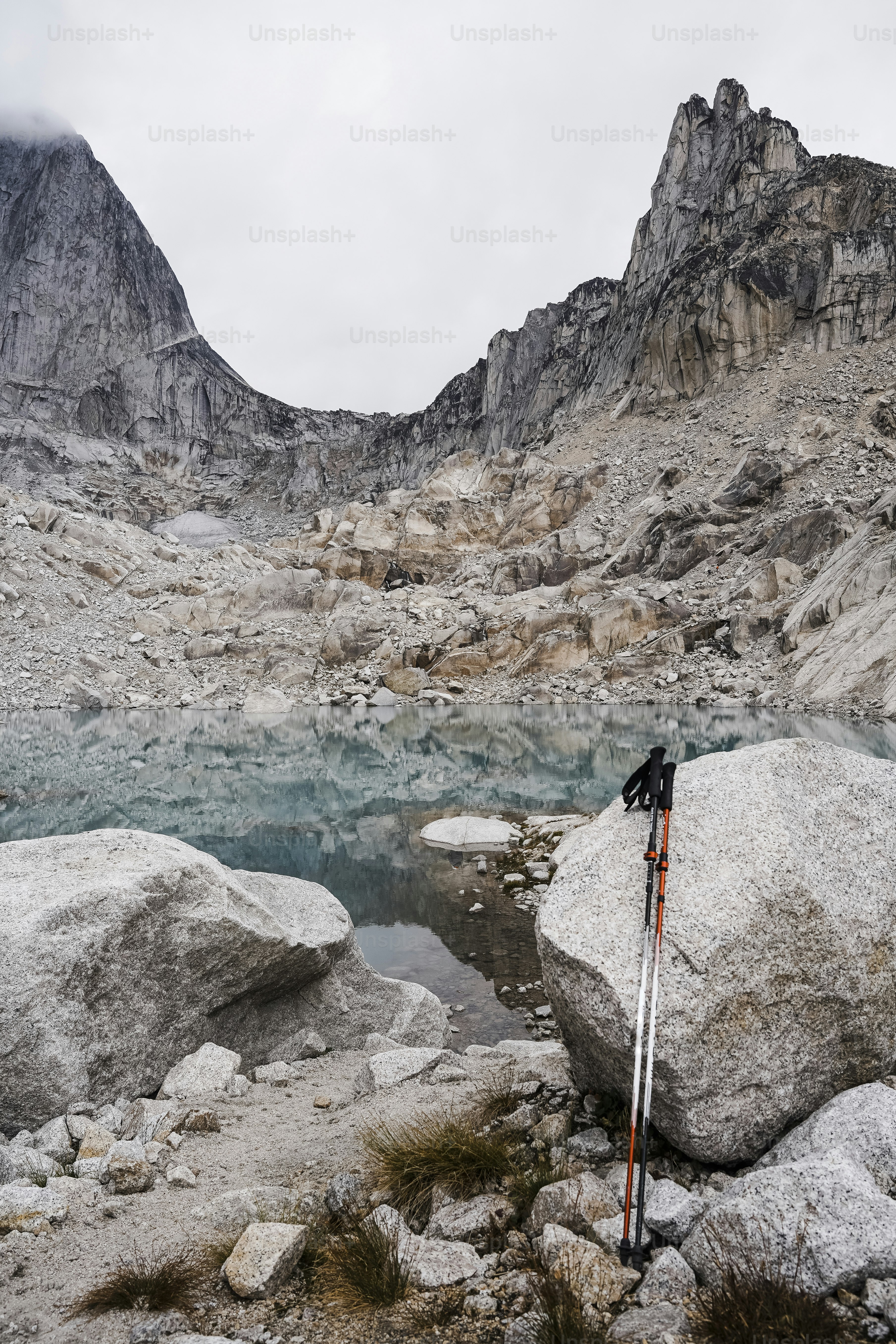 A pair of skis sitting on top of a large rock photo – Canada Image on ...