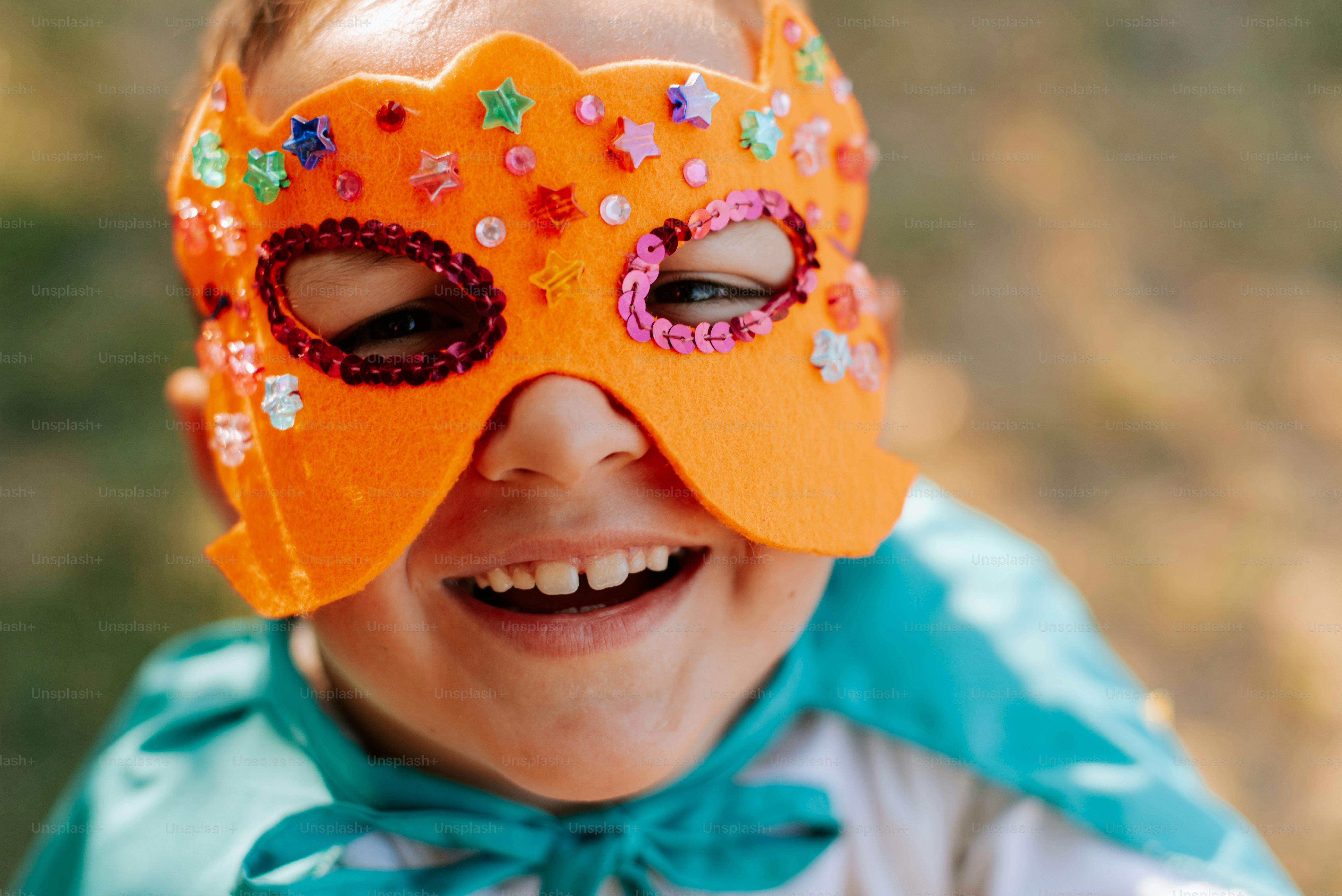 A young boy wearing a mask and smiling