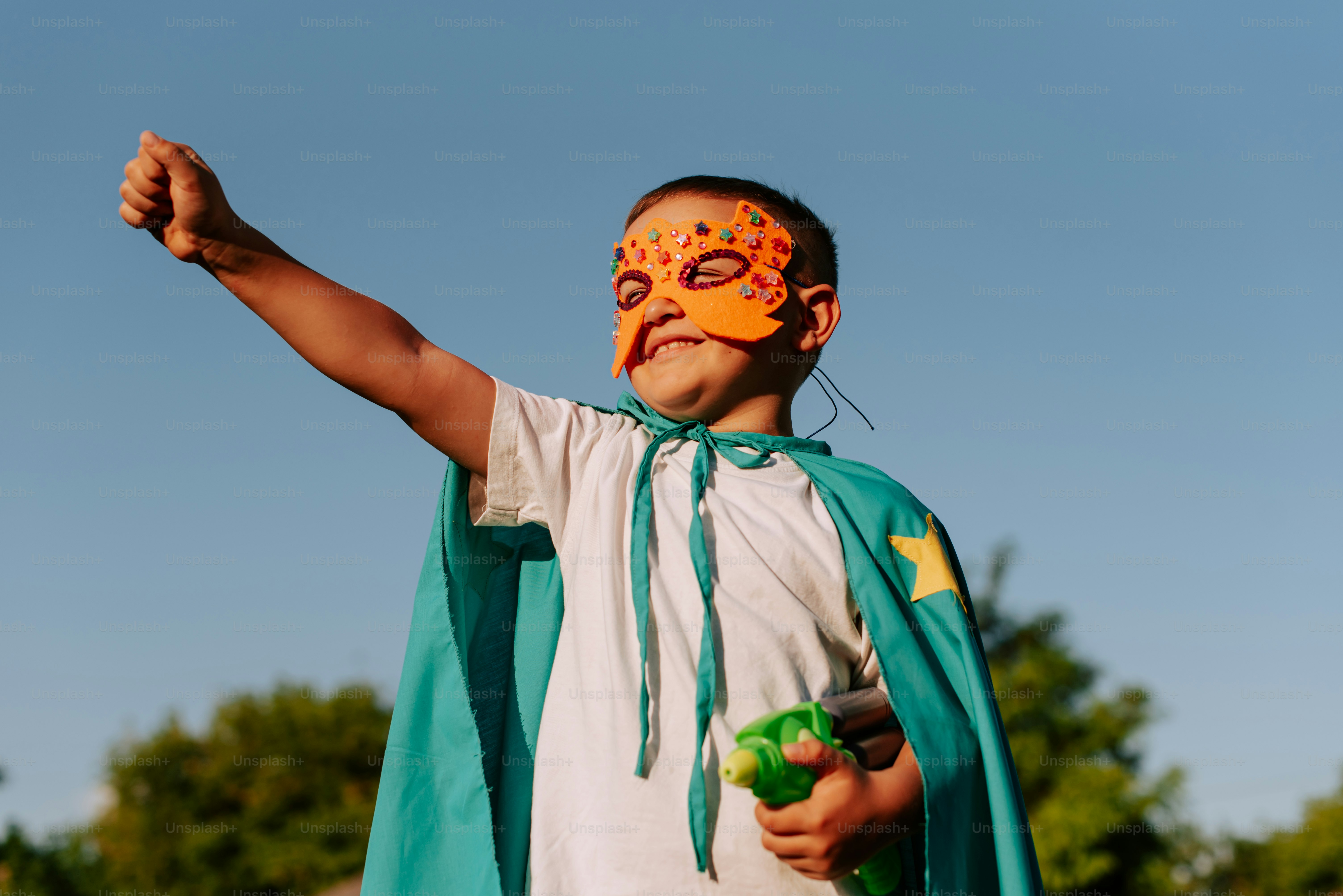 A young boy wearing a mask and cape