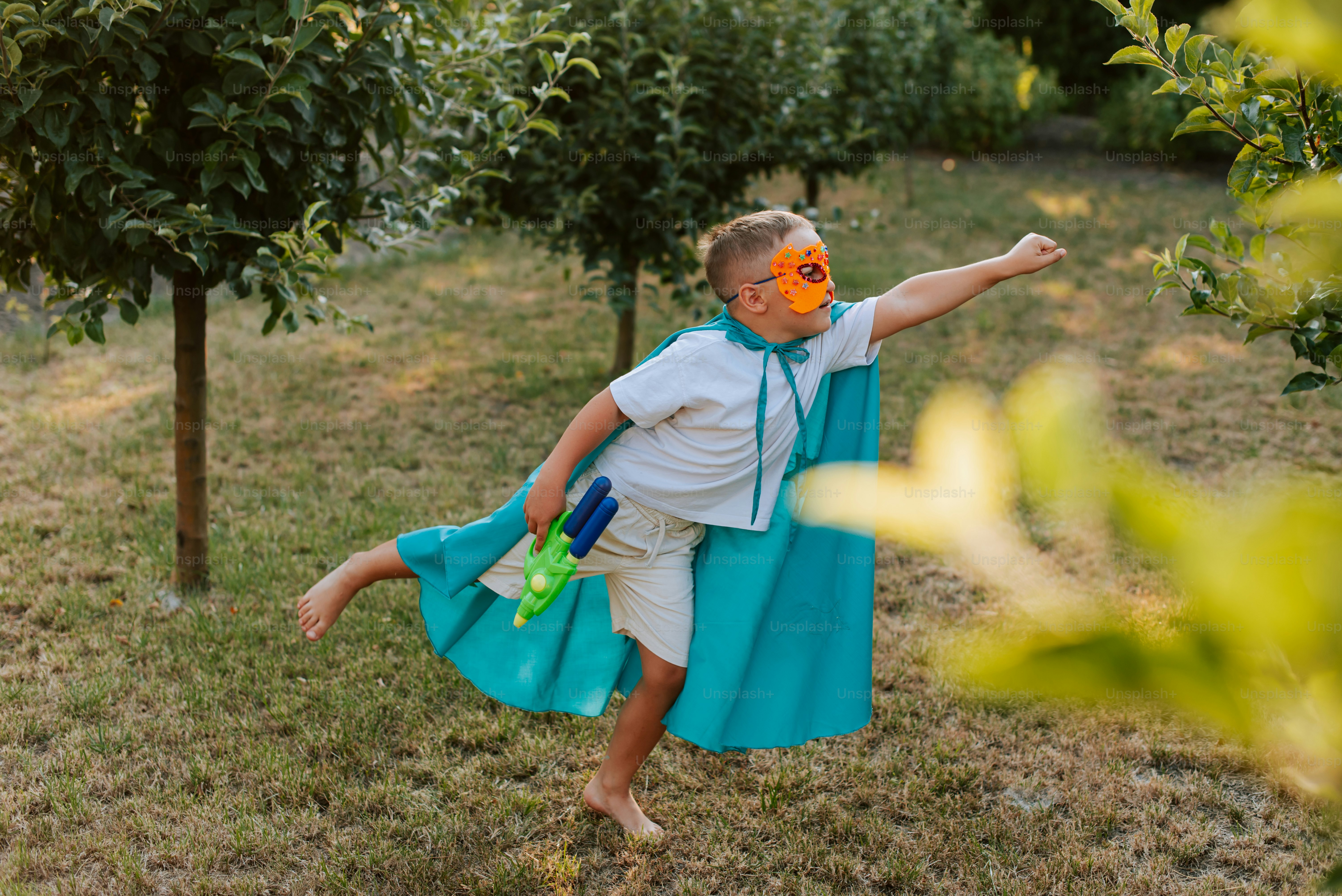 A man in a blue dress and orange mask in an apple orchard