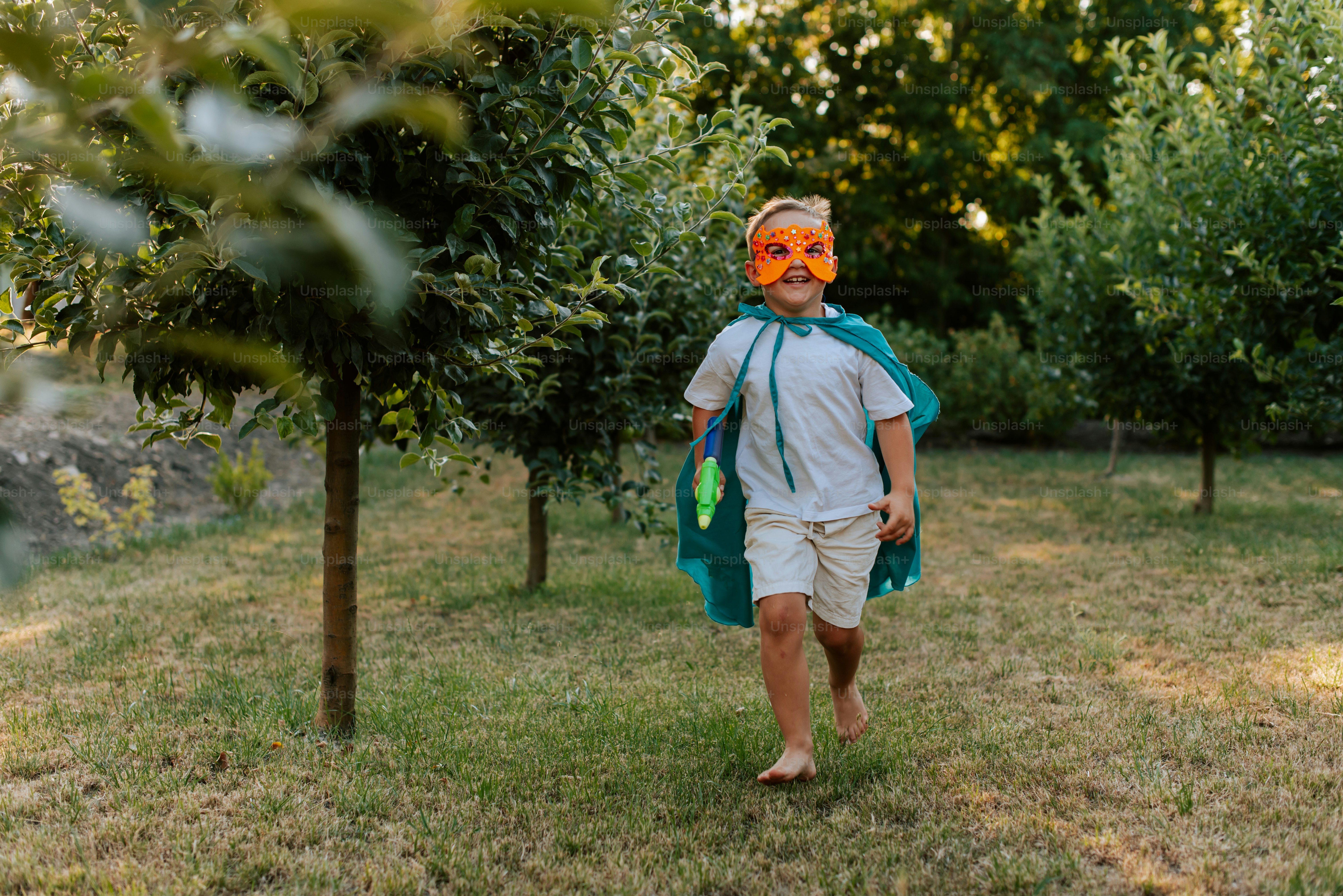 A man walking through an apple orchard with an orange mask on