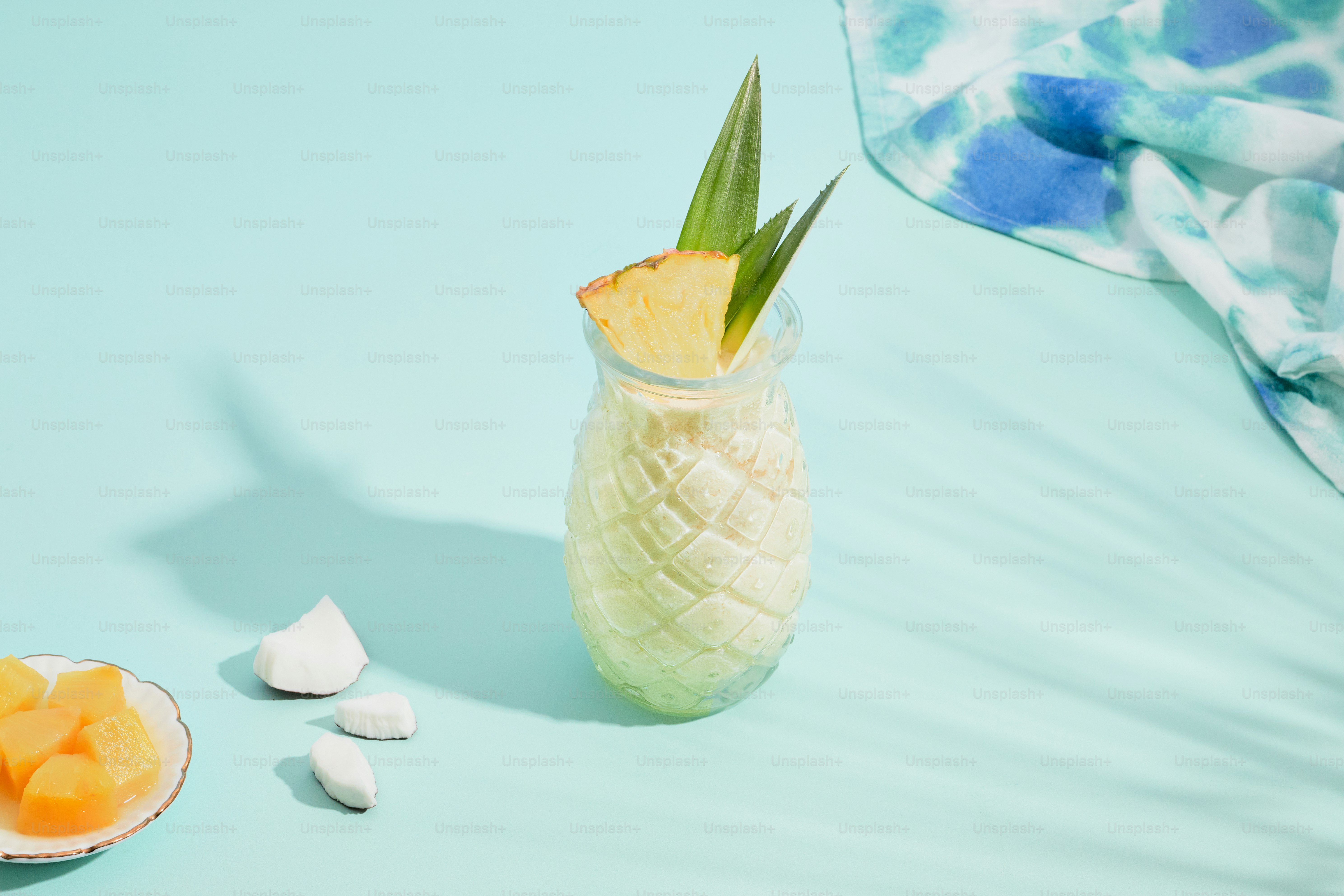 A glass vase filled with fruit and marshmallows