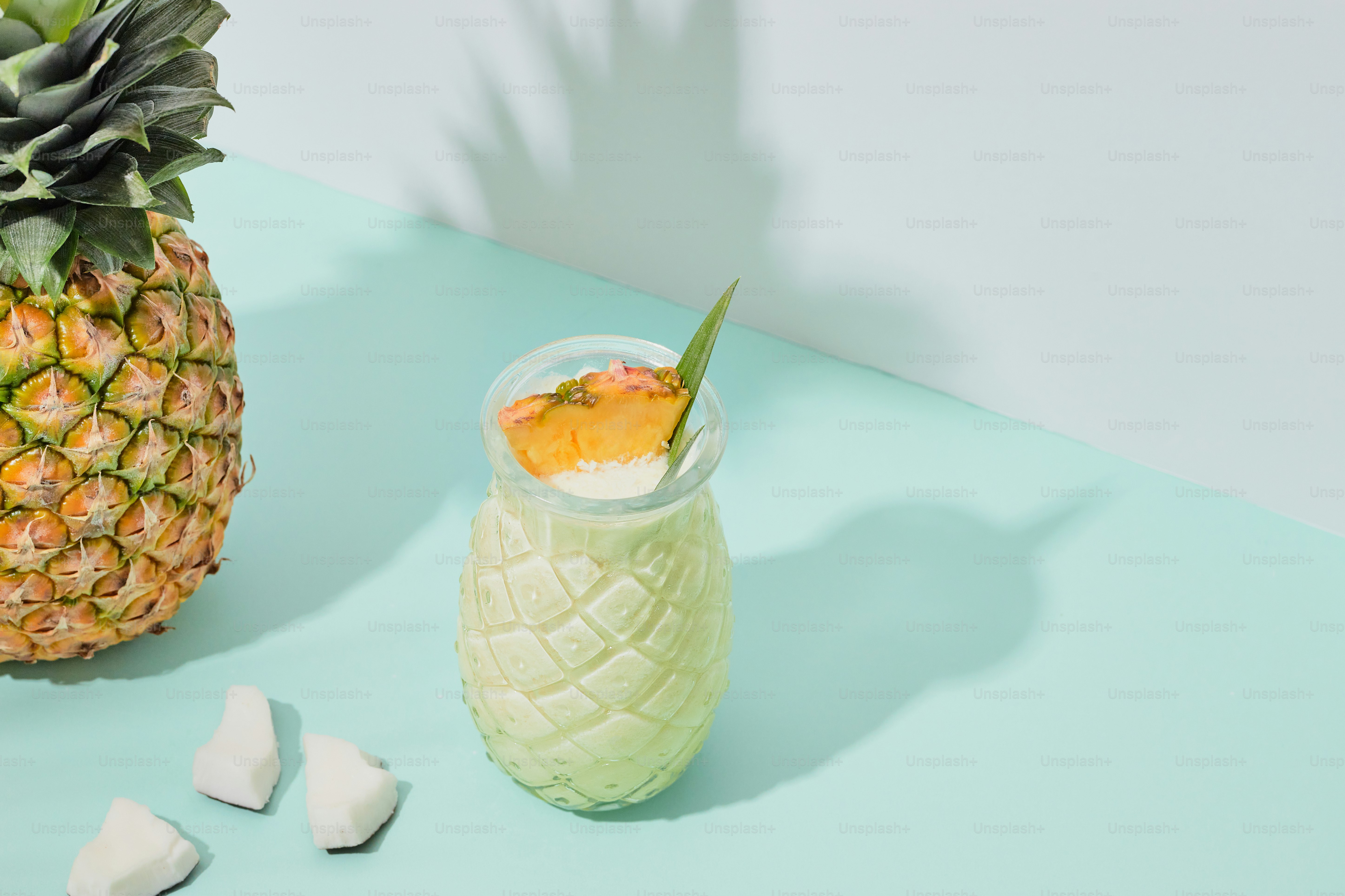 A pineapple and marshmallows on a table