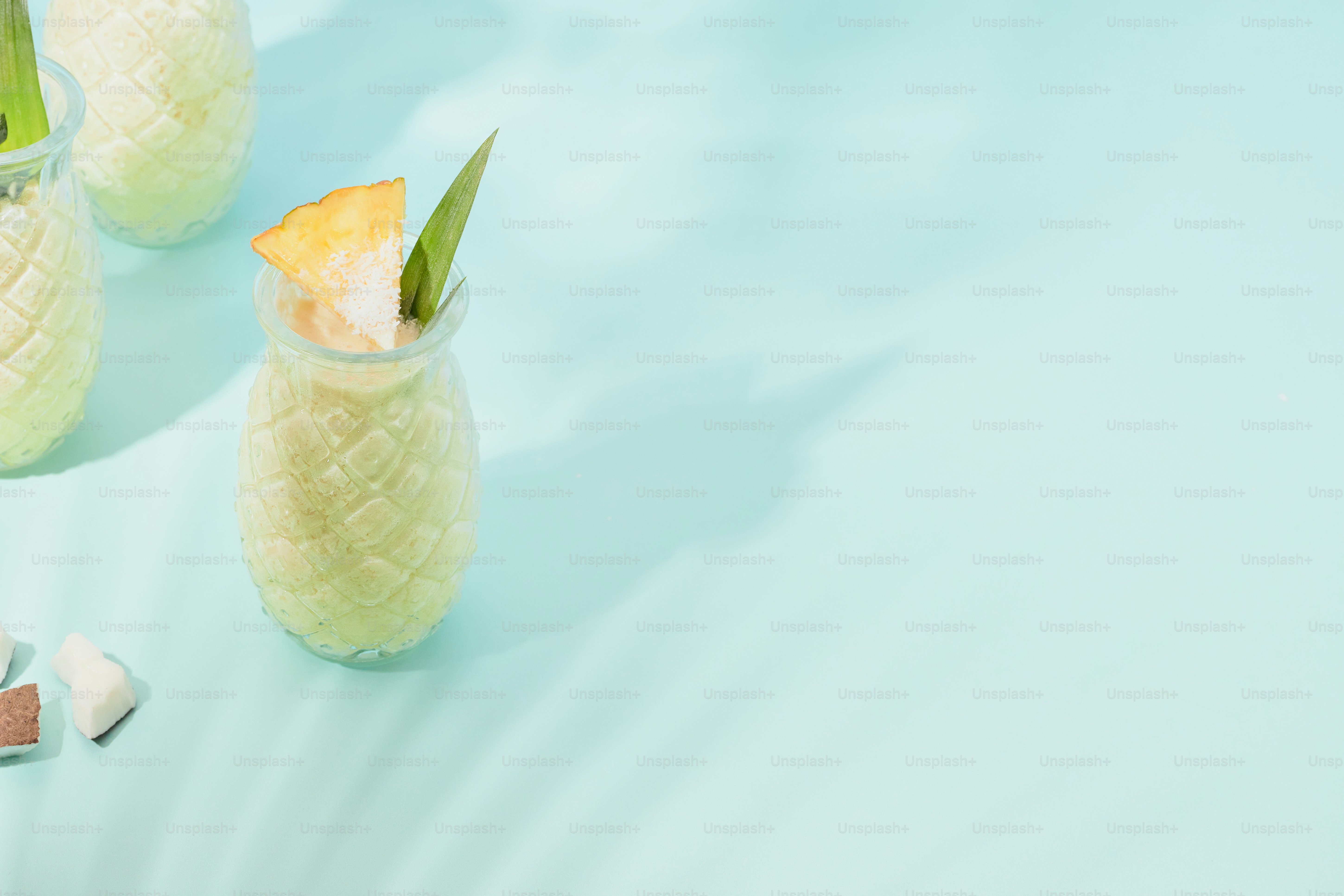A table topped with three glasses filled with drinks