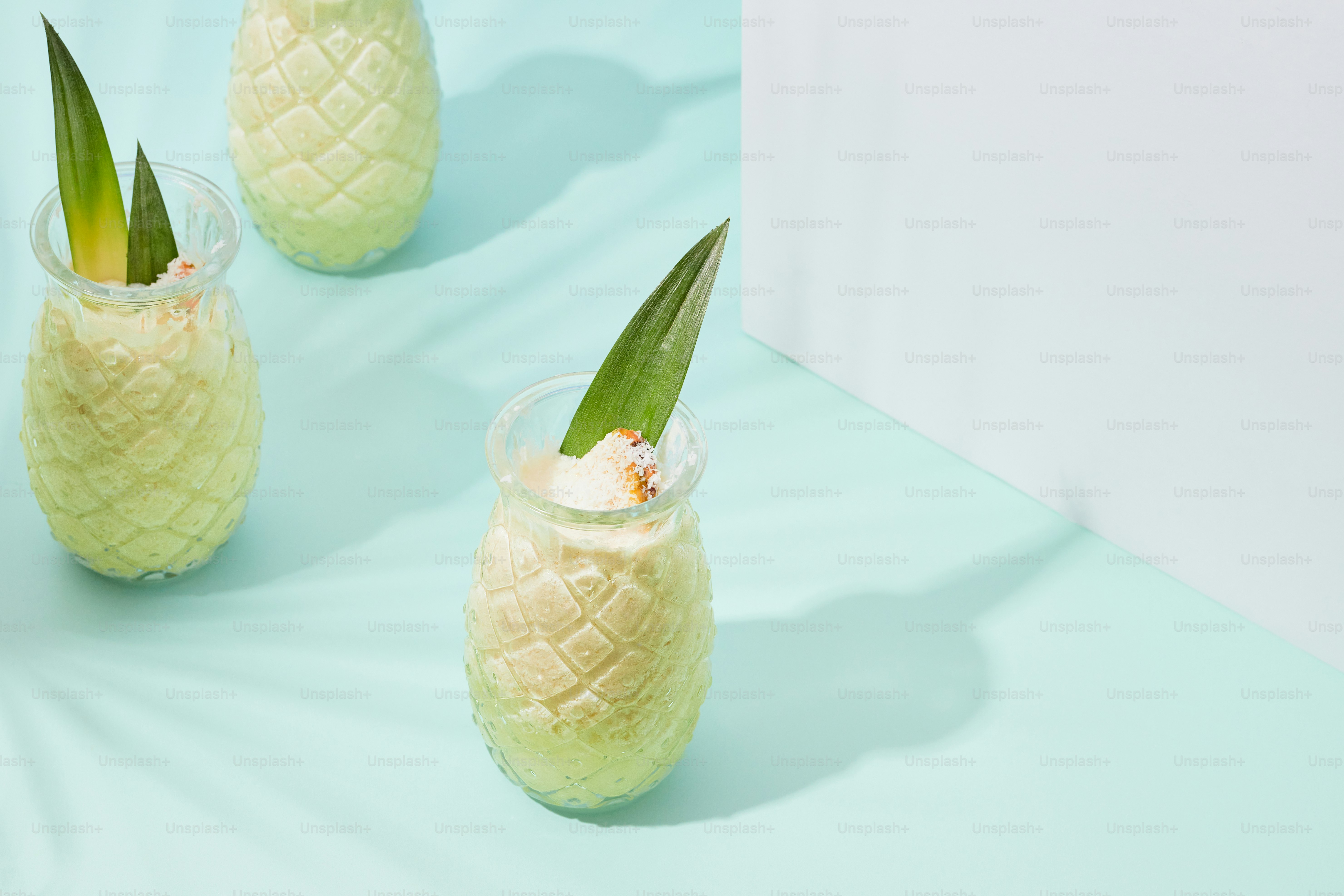 Three pineapple shaped vases filled with whipped cream