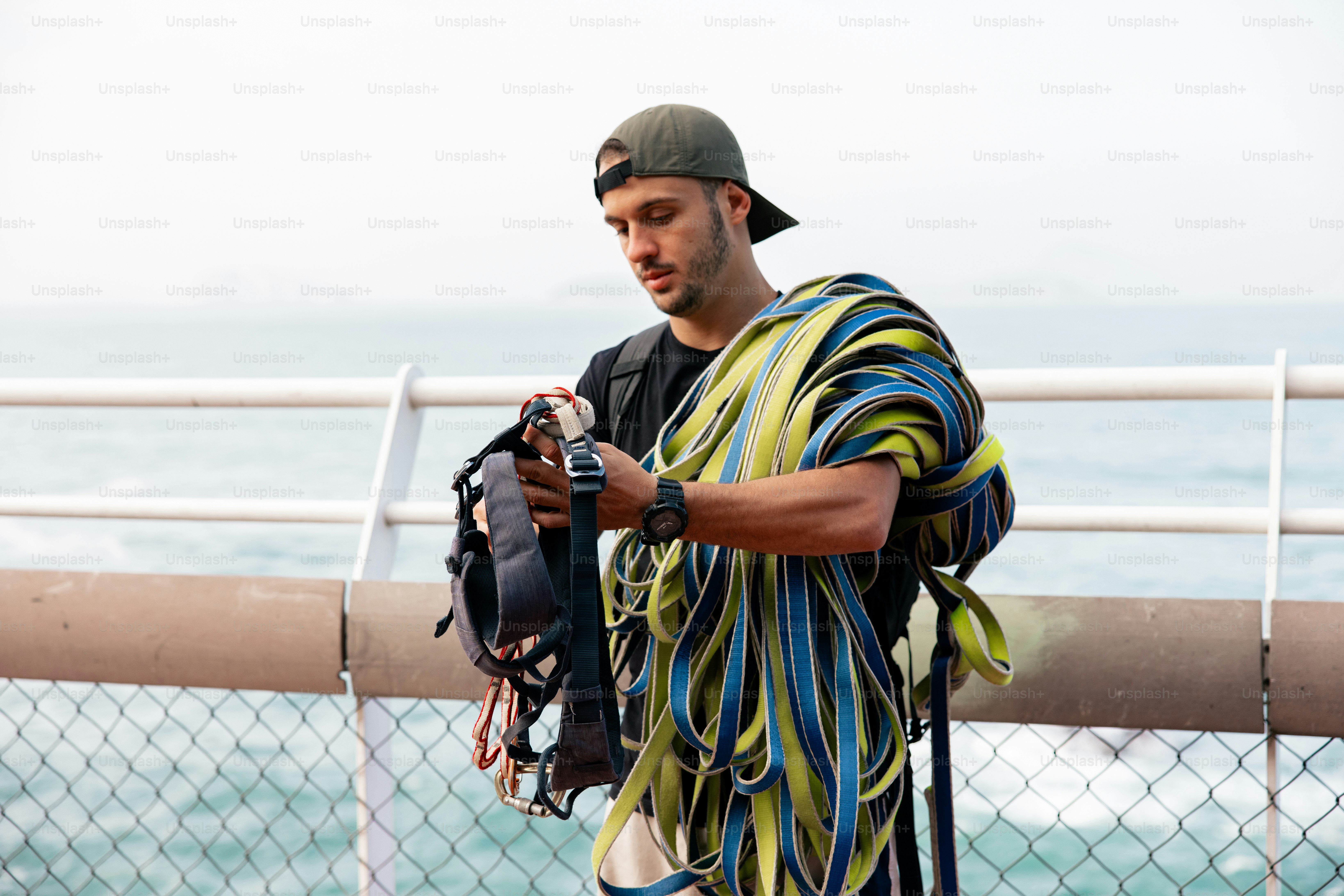 A man standing on a pier with a camera in his hand