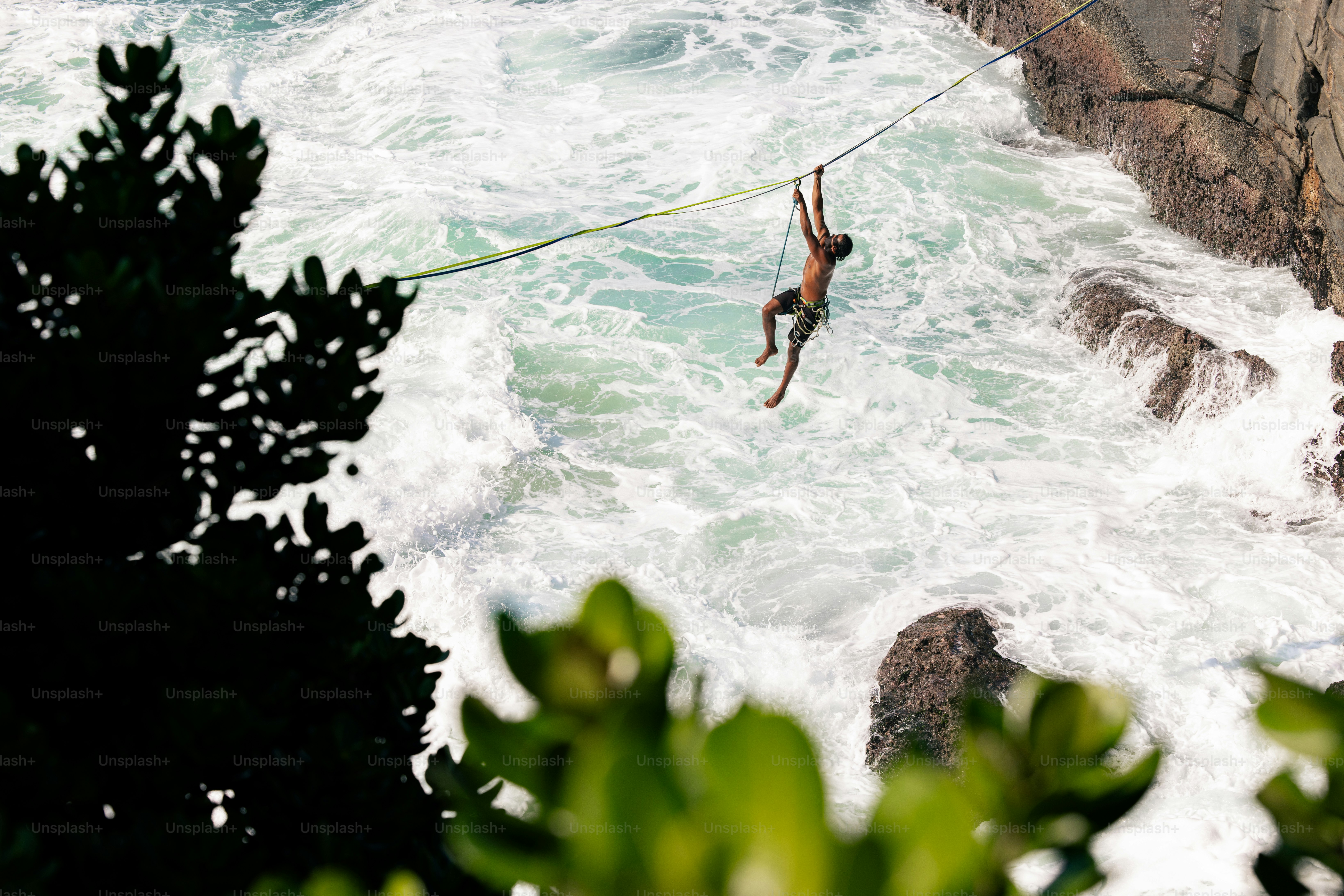 A man is in the air above the water