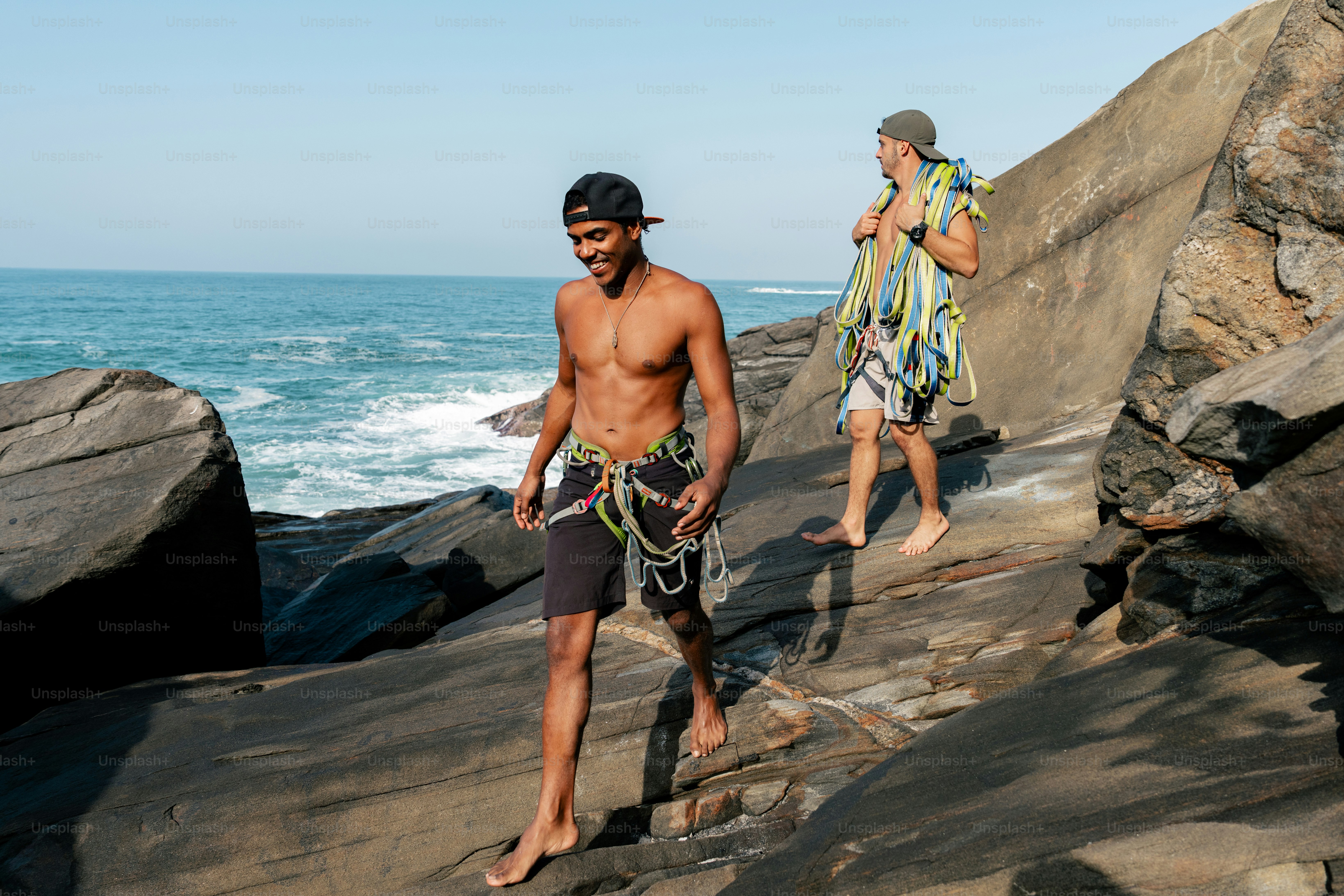 A couple of men standing on top of a cliff