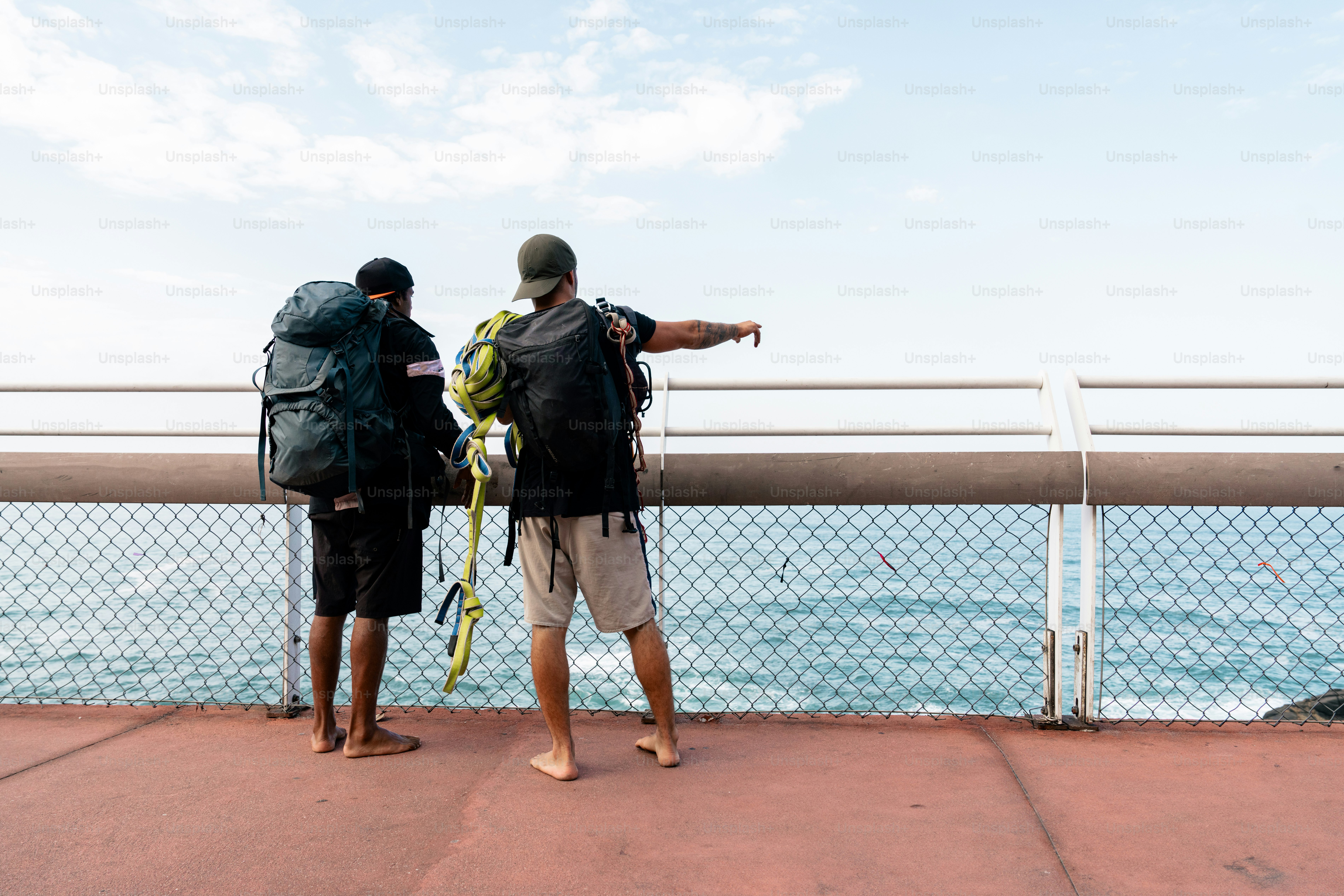 A couple of men standing on top of a bridge