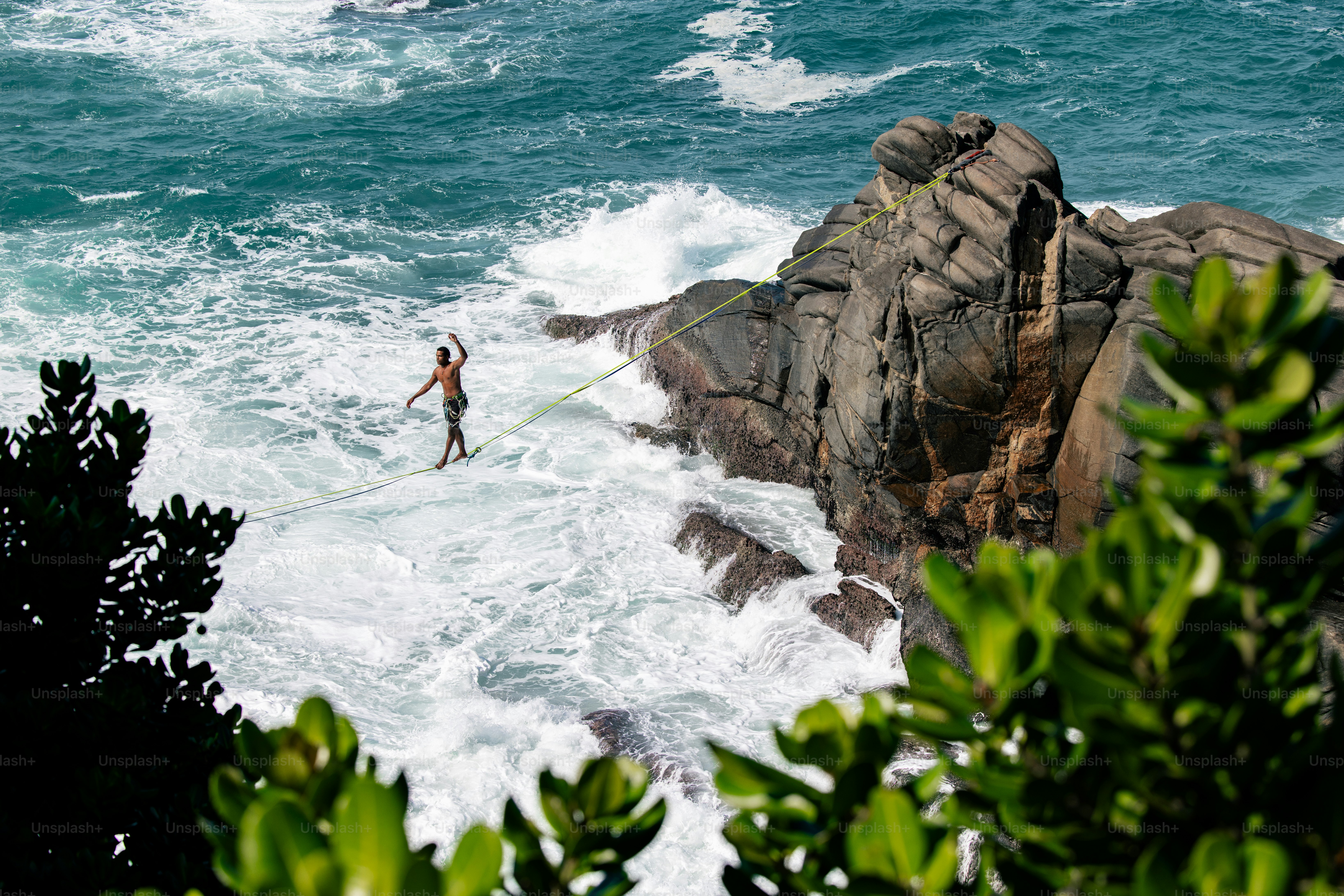 A person standing on a surfboard in the ocean