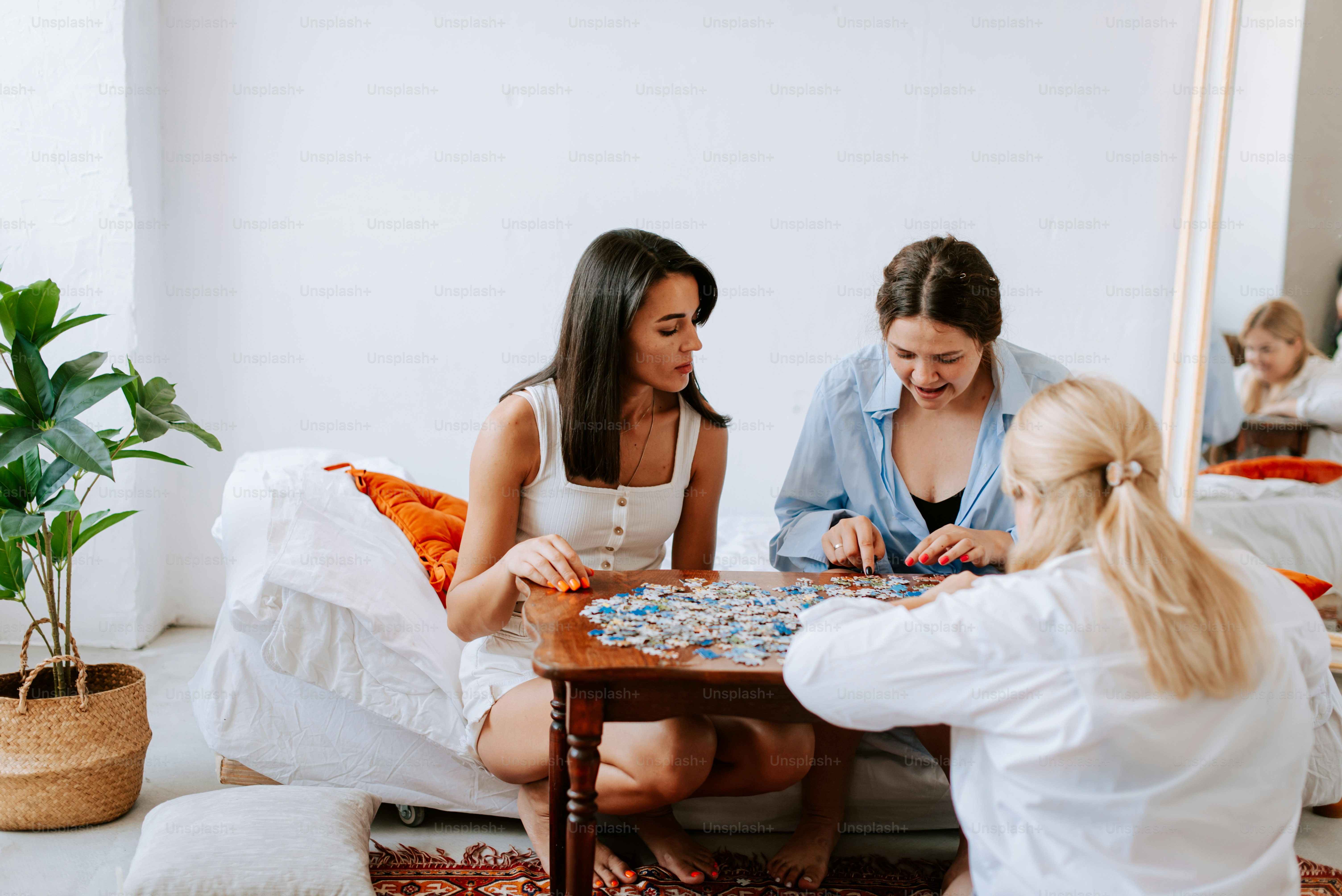 A group of women sitting around a table playing a game