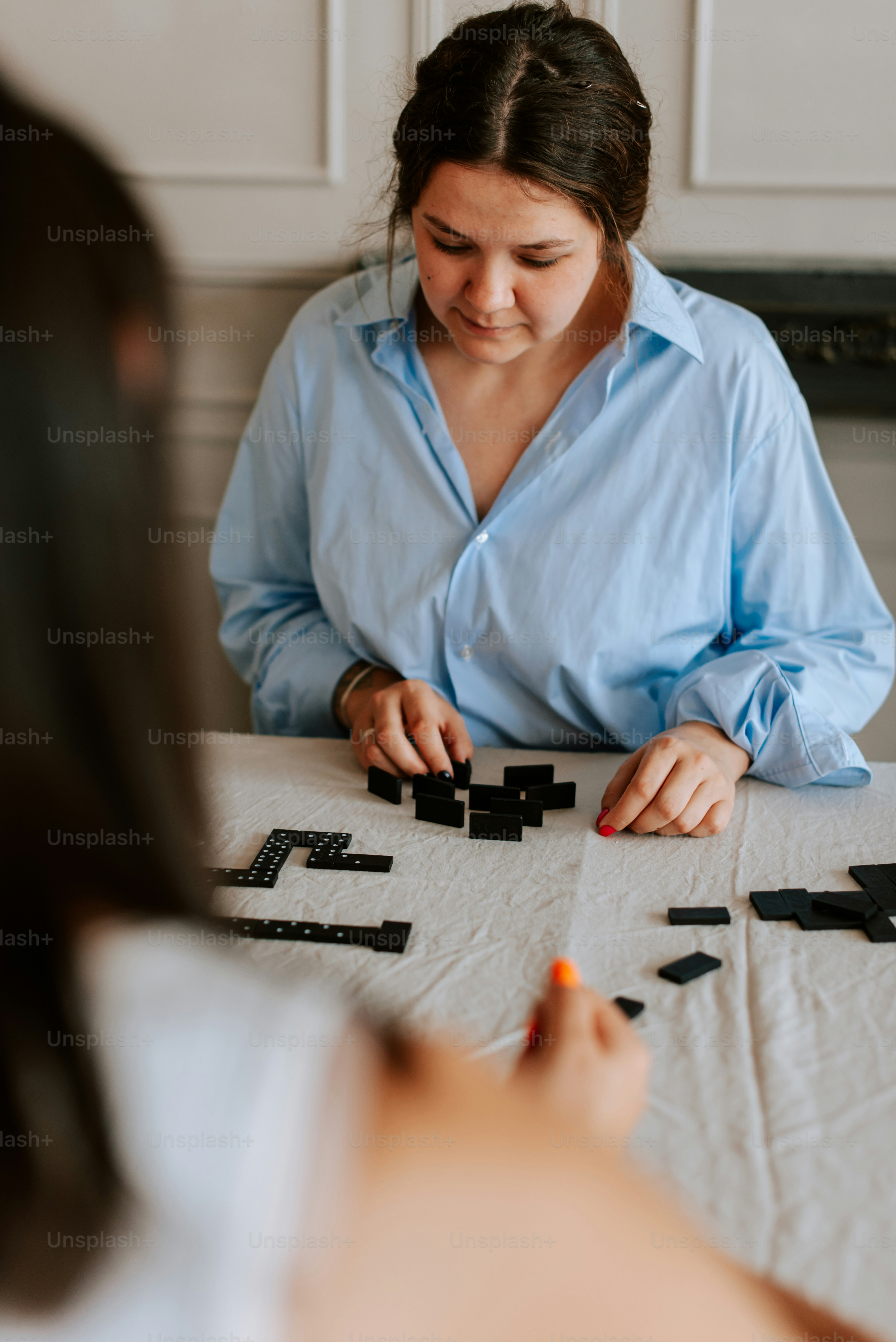 A woman sitting at a table working on a project