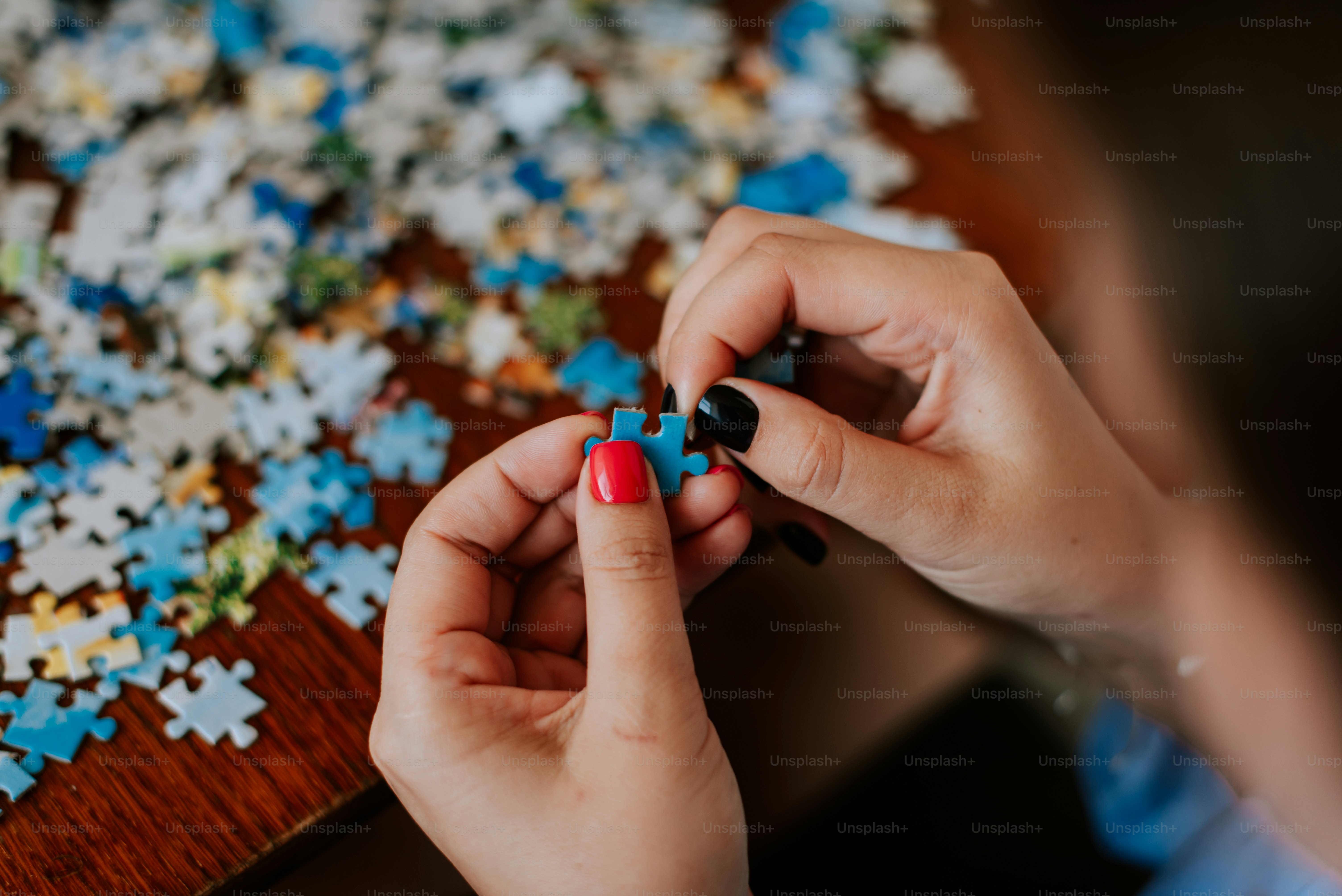 A woman putting a piece of a puzzle together