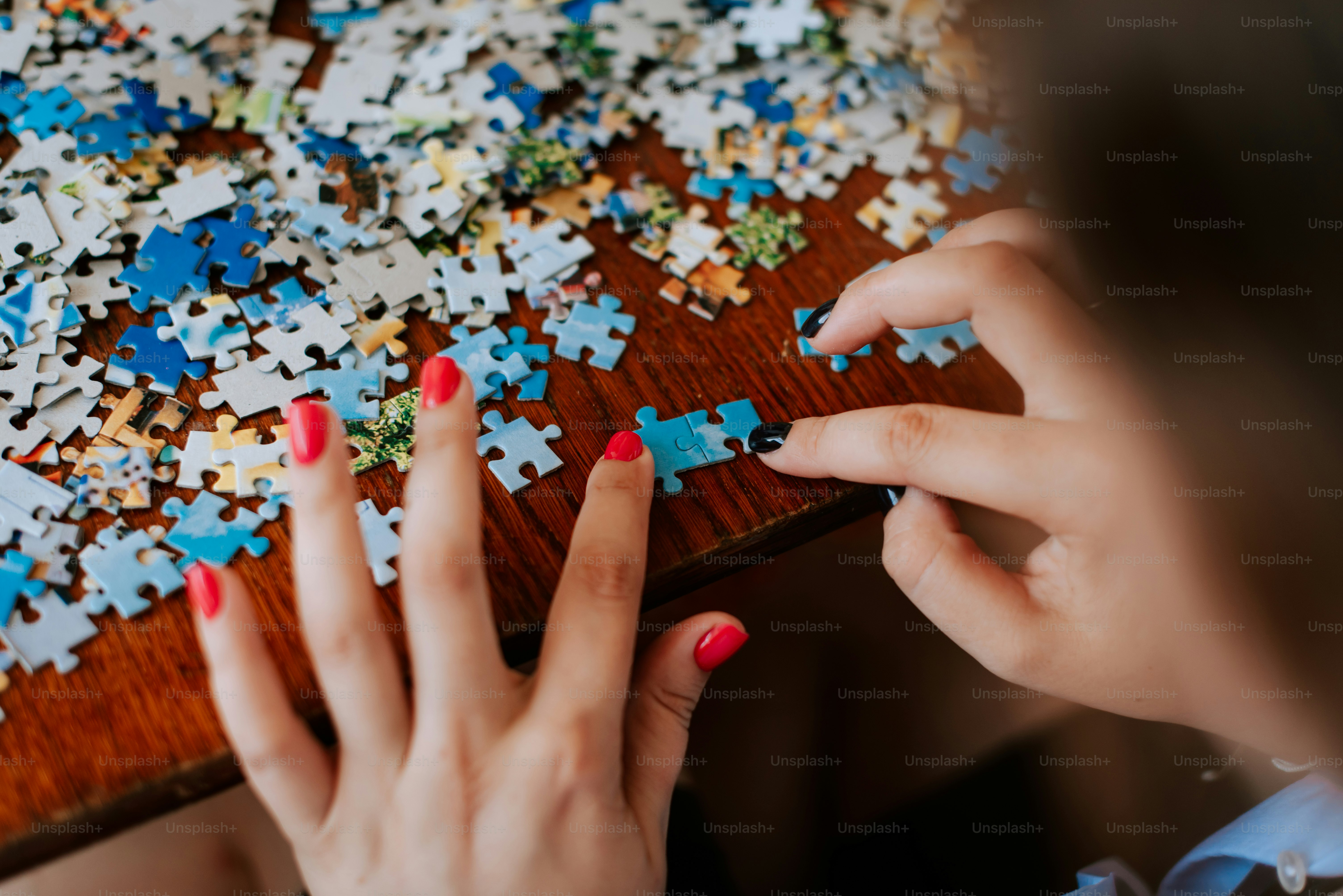 A woman putting together a puzzle on a table