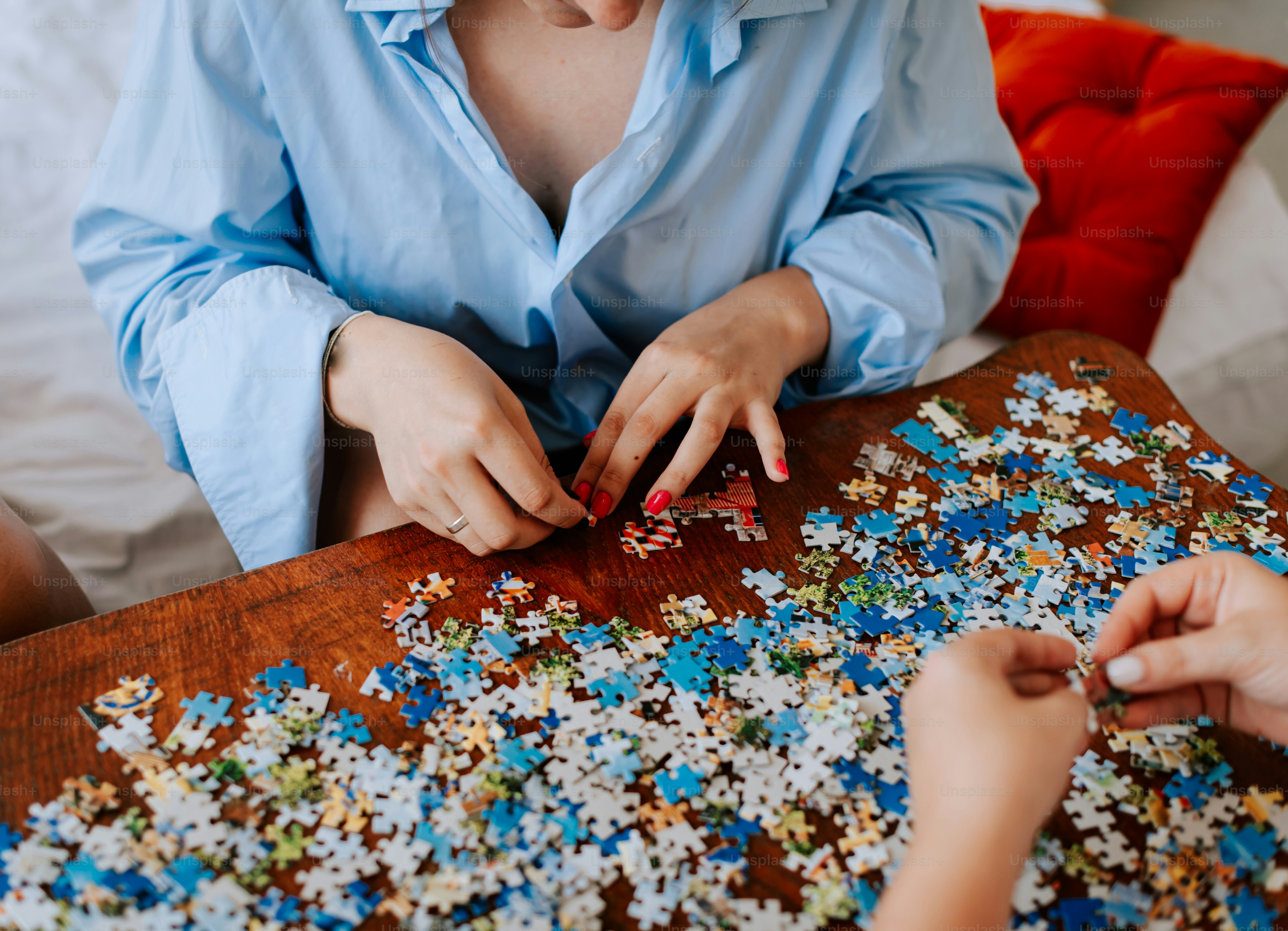 A woman and a child are playing with a puzzle