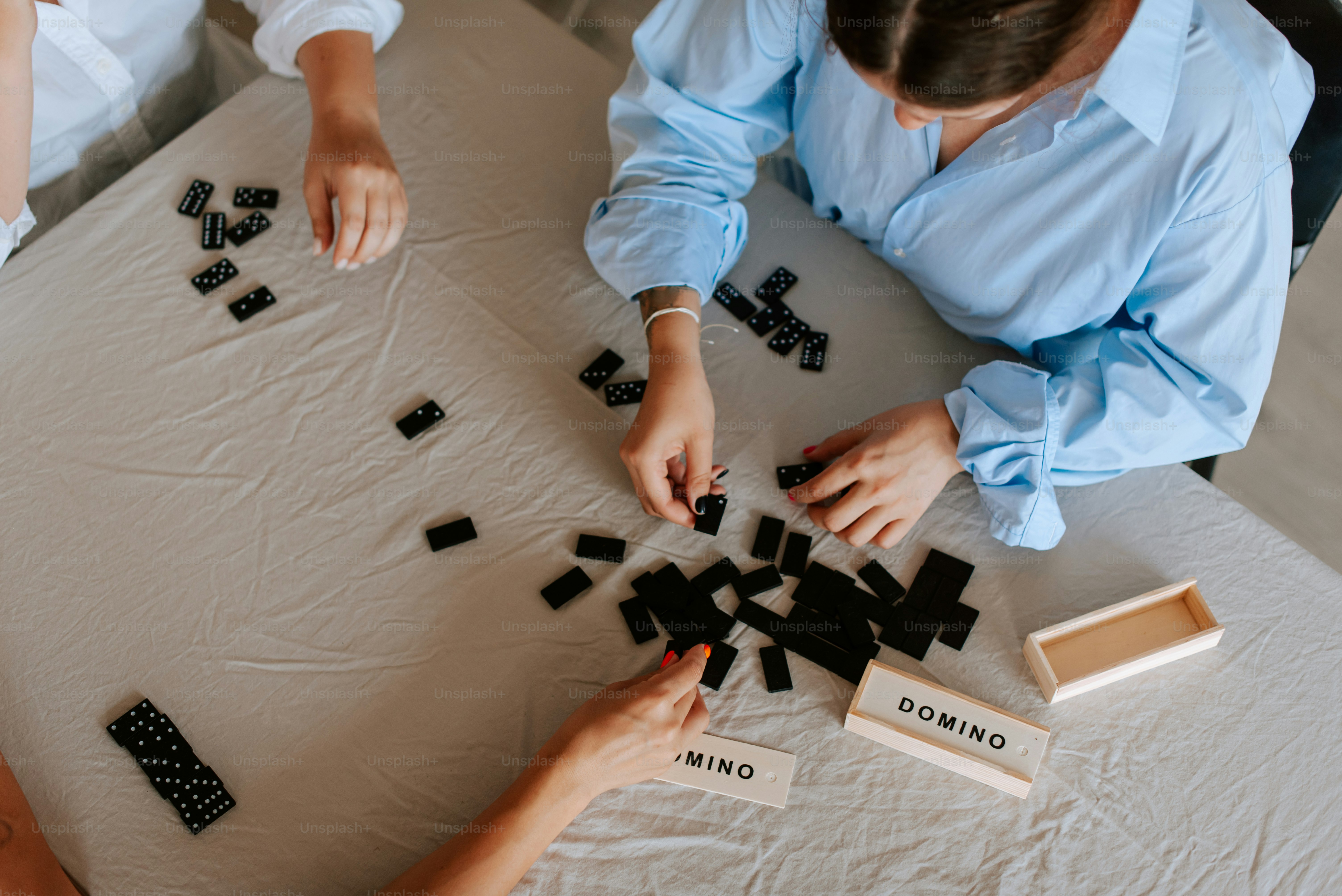 A group of people sitting around a table playing a game
