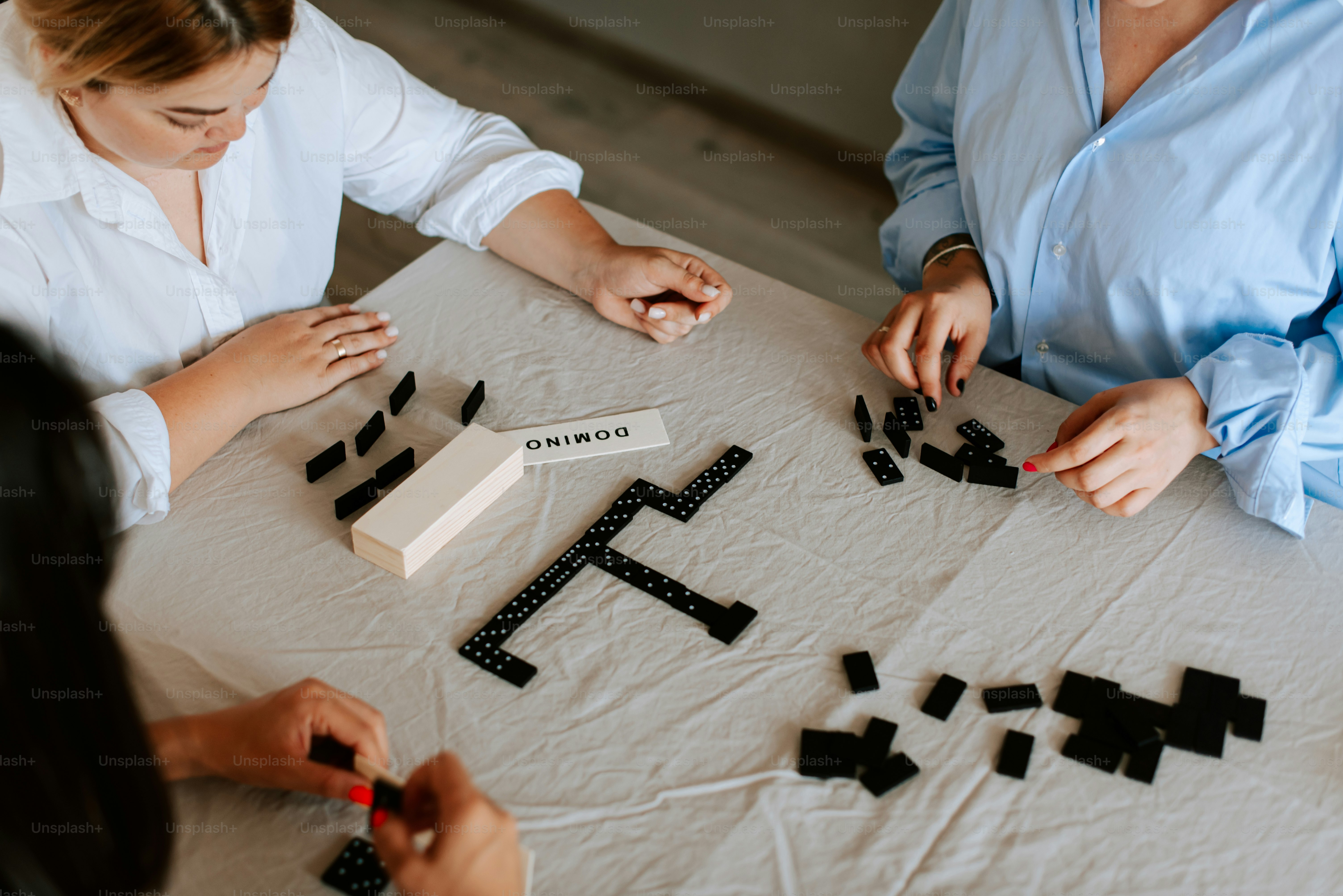 A group of people sitting around a table playing a game