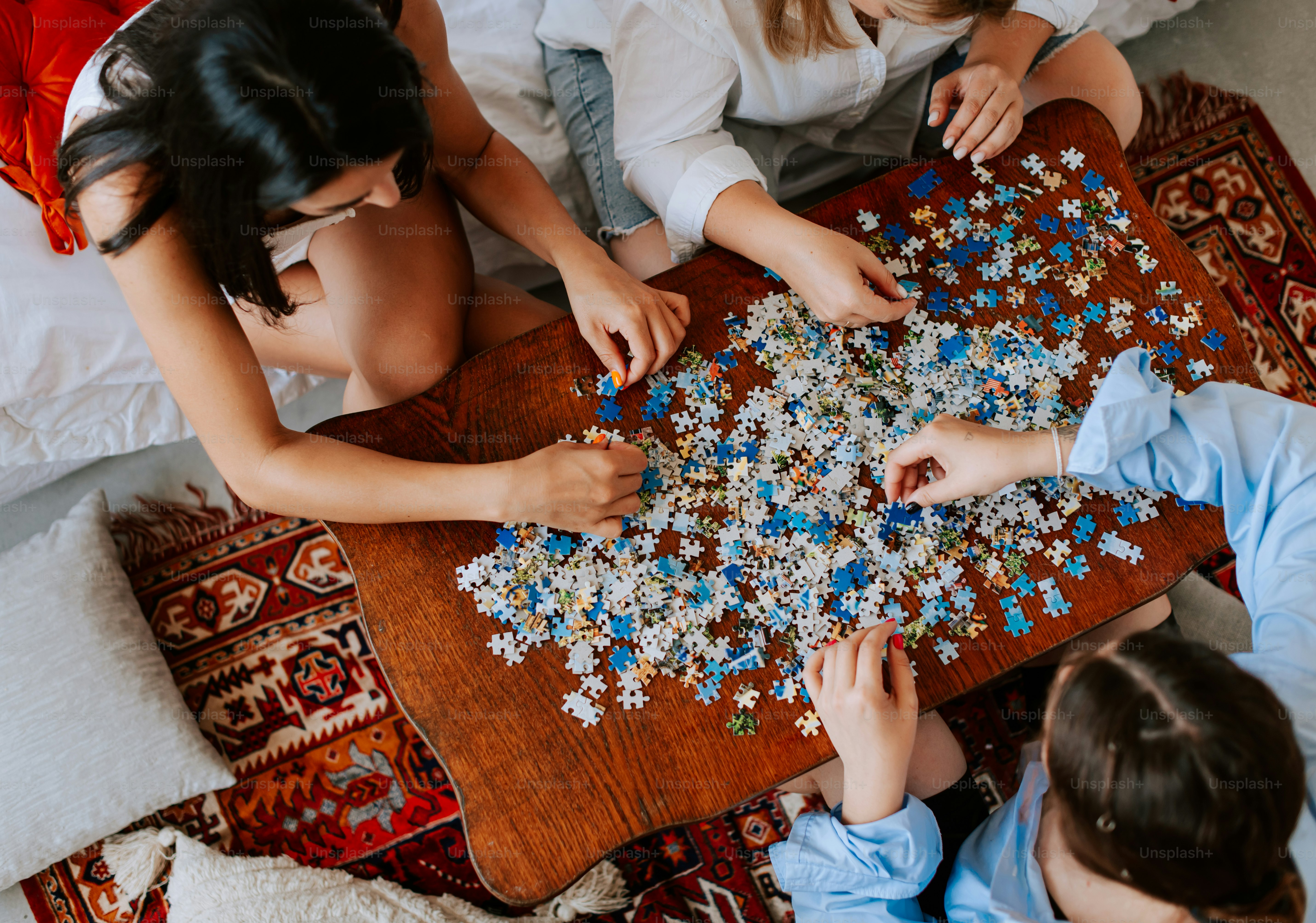 A group of people sitting around a table playing a game