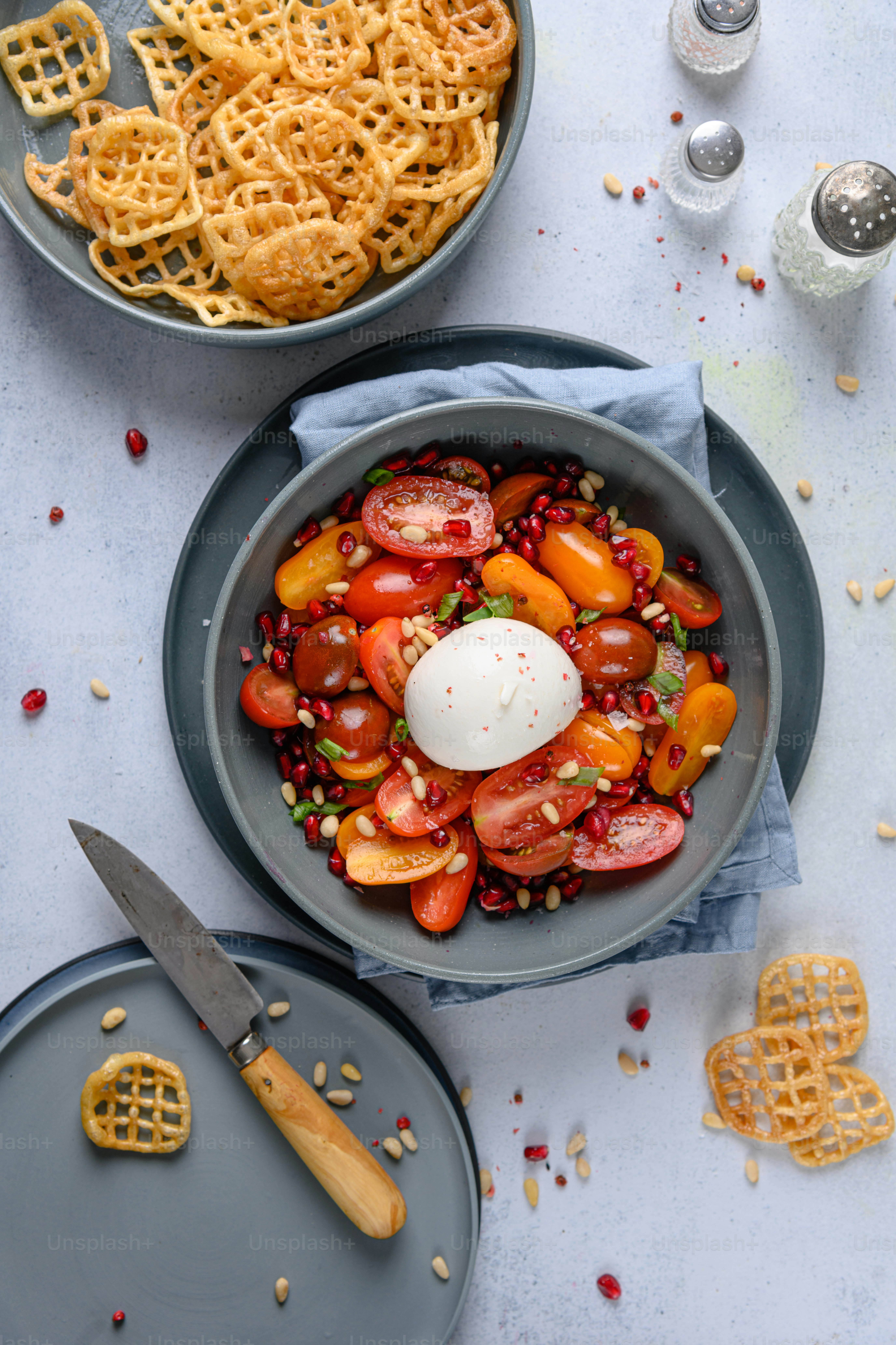A table topped with two bowls filled with food
