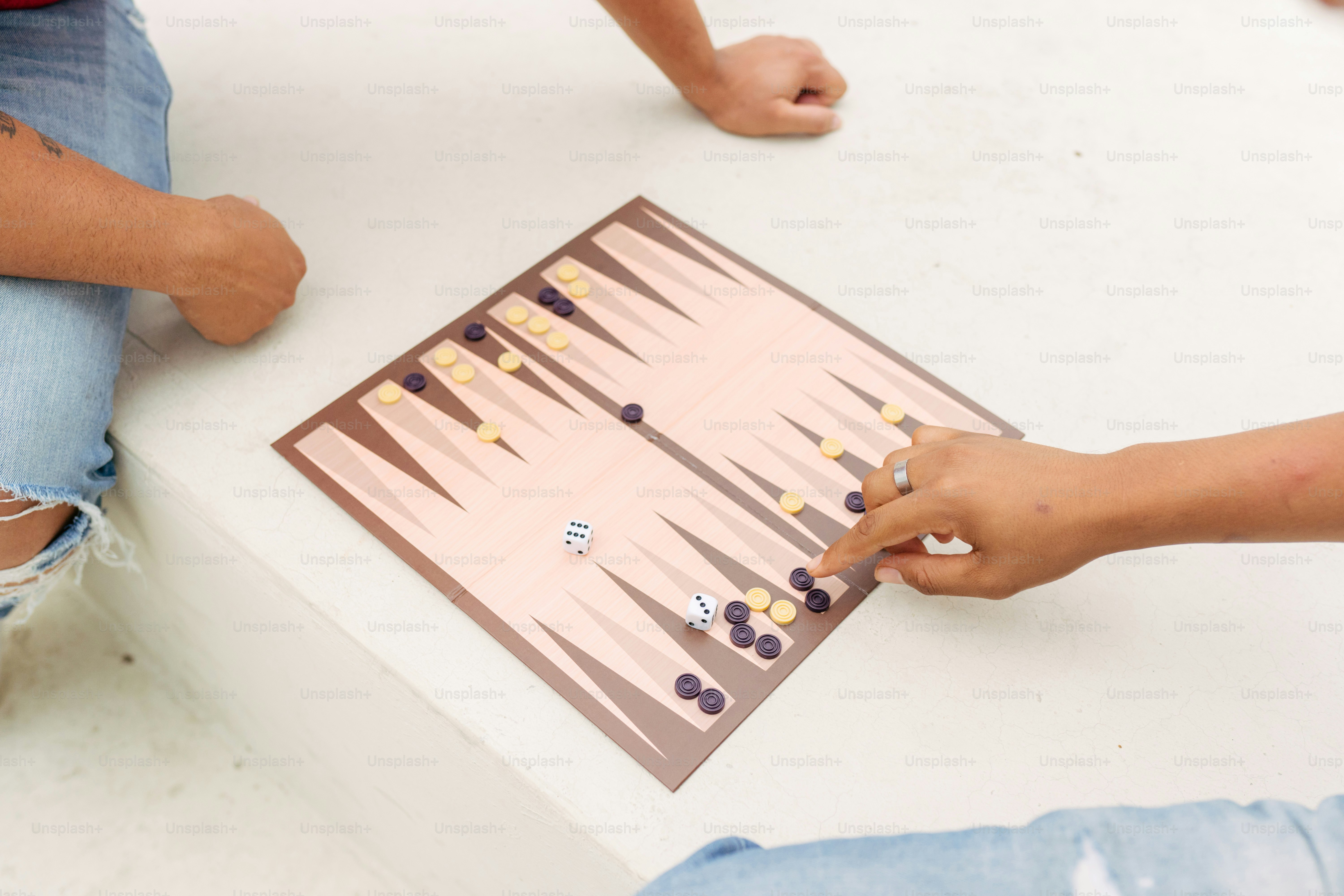 A group of people sitting around a table playing a game