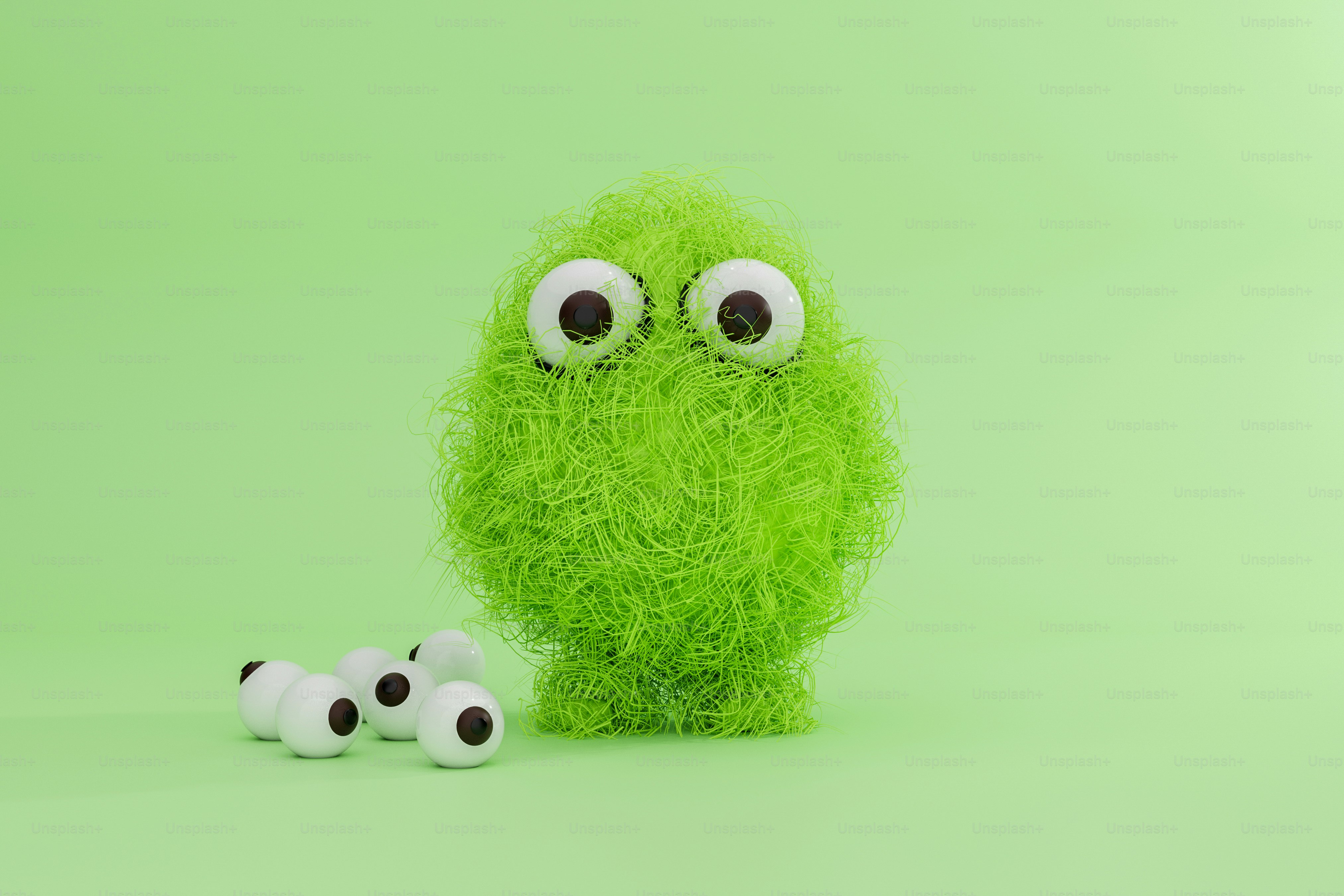 A green stuffed animal with two smaller ones