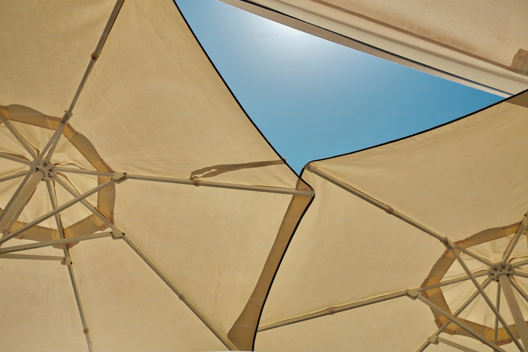 A group of umbrellas with a blue sky in the background